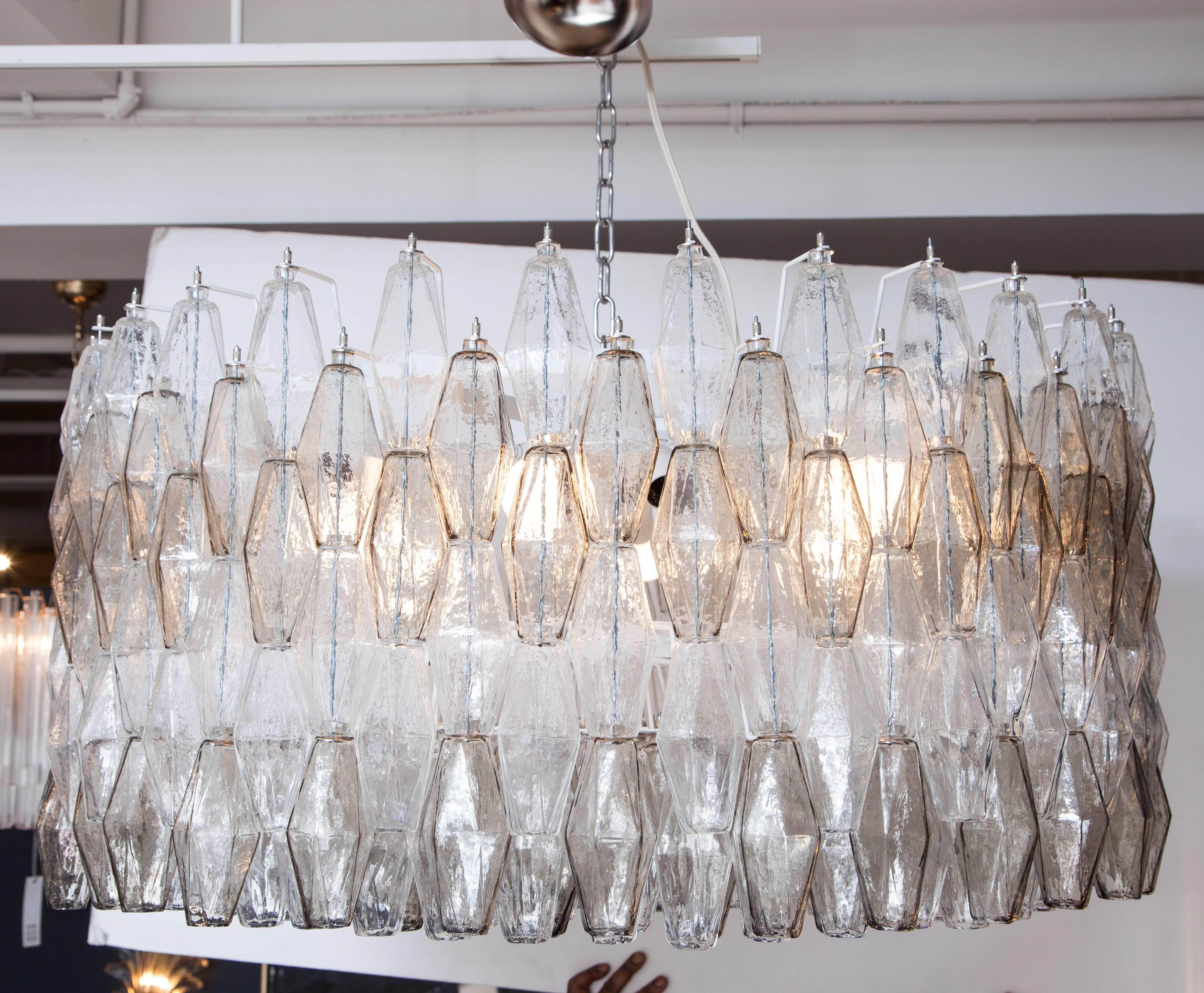 This Venini style Italian five-tier chandelier is absolutely breathtaking. Consisting of hundreds of individually handblown polyhedral-shaped glass elements in alternating colors of grayish smoke taupe and clear suspended from a polished chrome