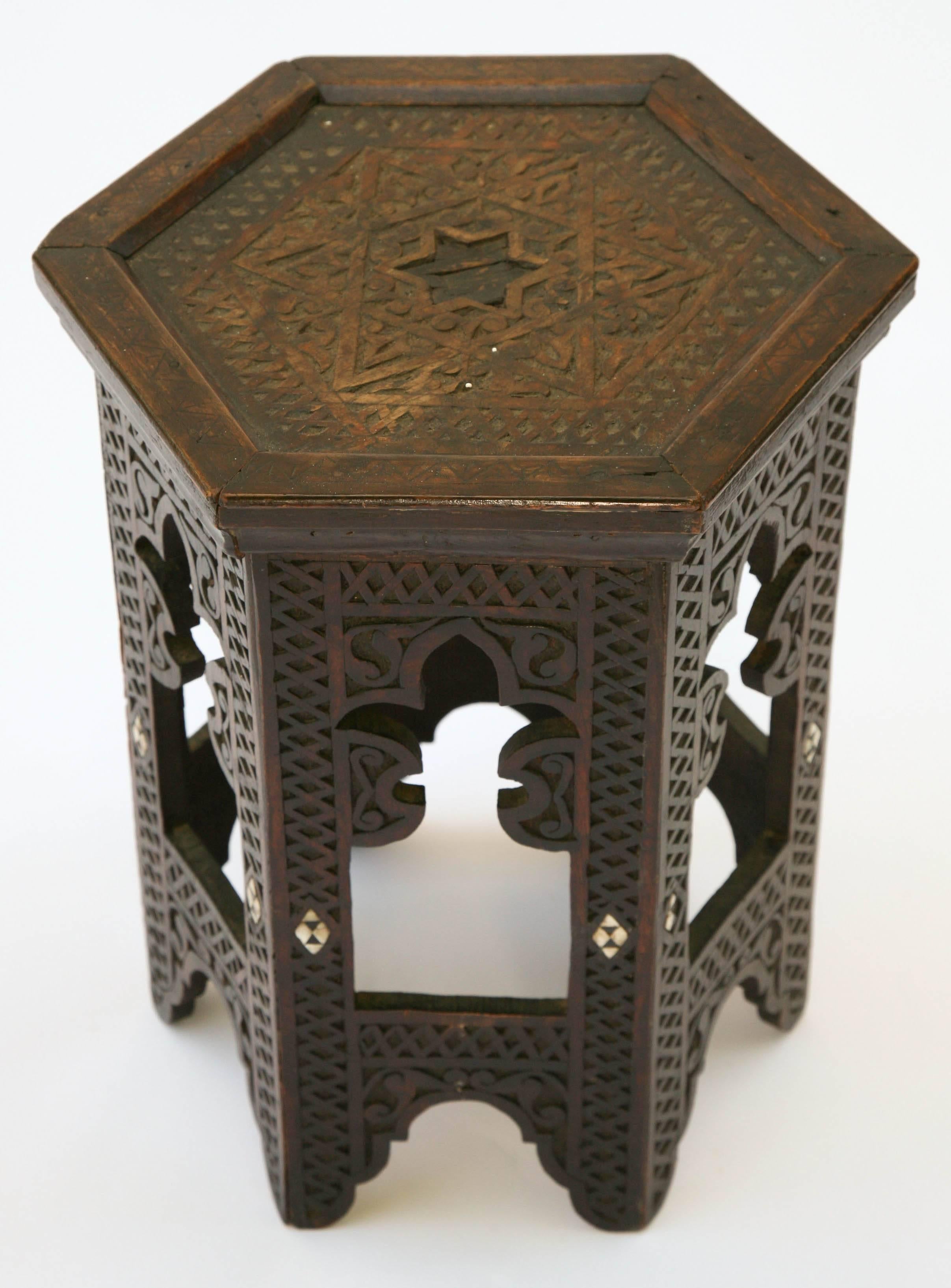 Accent table, of rosewood, having an octagonal top with star pattern decoration, on conforming base, with pieced legs, and elaborate in-carved crosshatching, bone inlay accents.

Stock ID: D9326