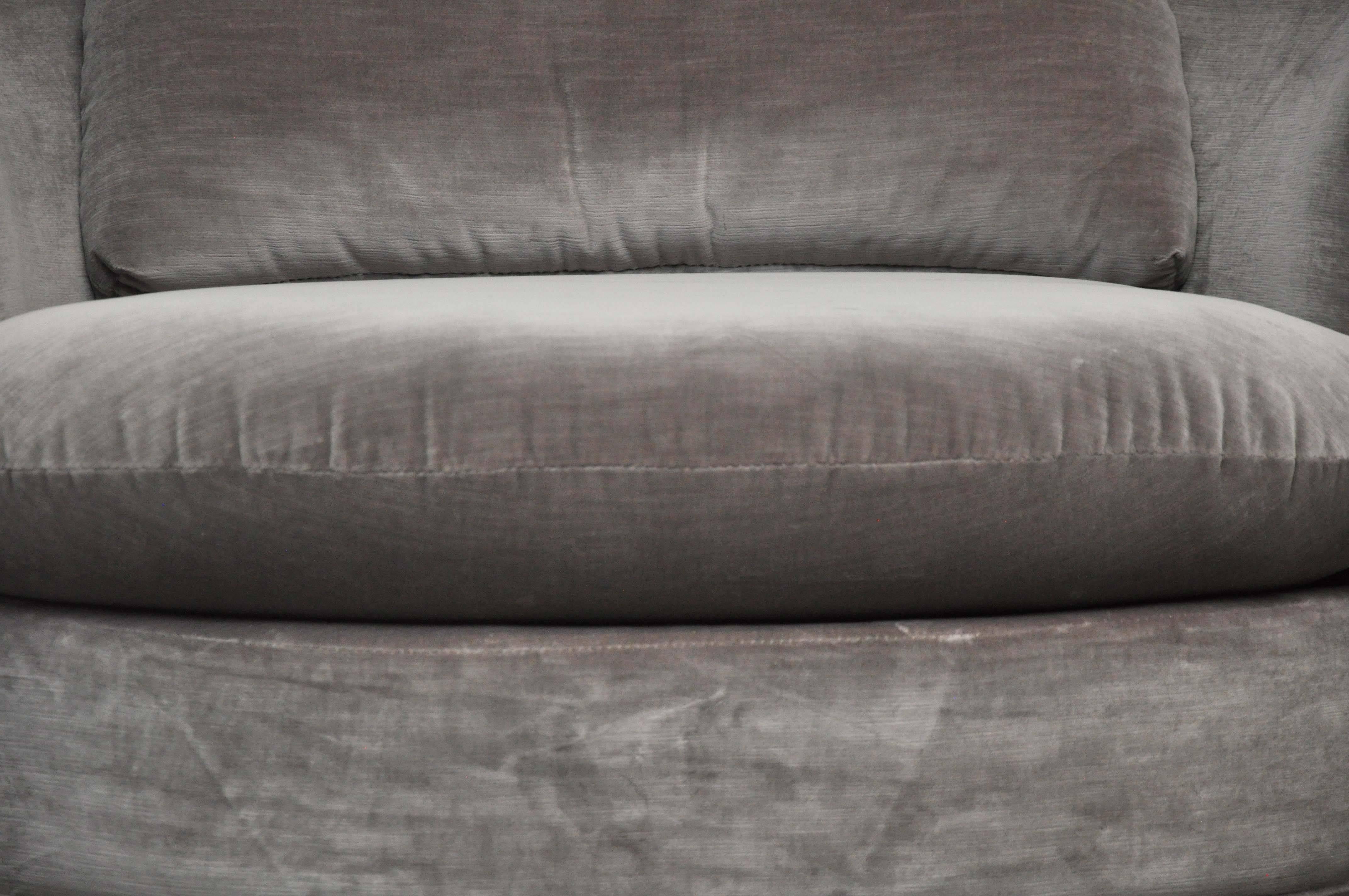 Large-scale swivel chair by Milo Baughman. New velvet upholstery over refinished walnut swivel base.