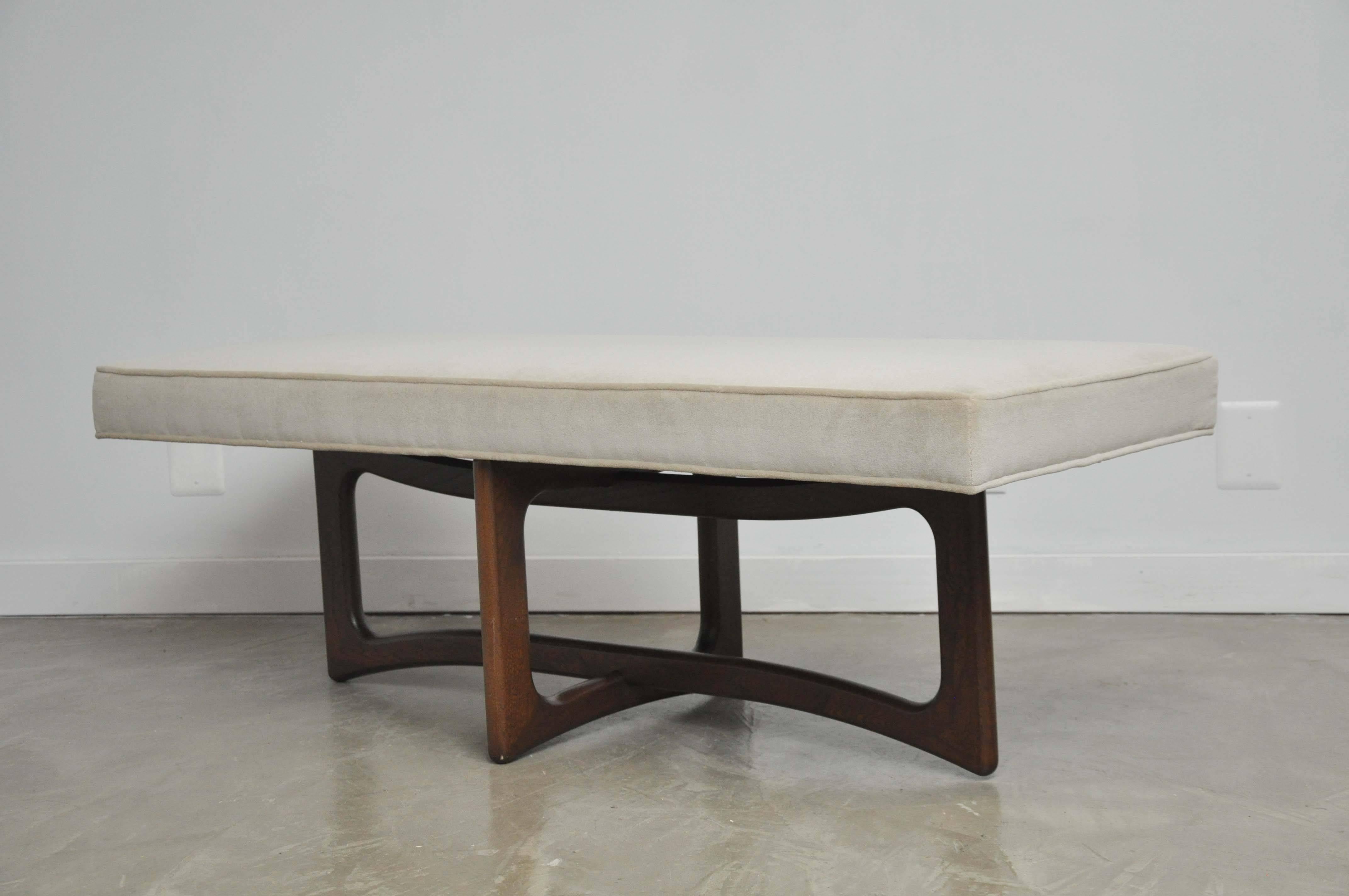 Mid-Century sculptural walnut base bench with new cream upholstered cushion. 

