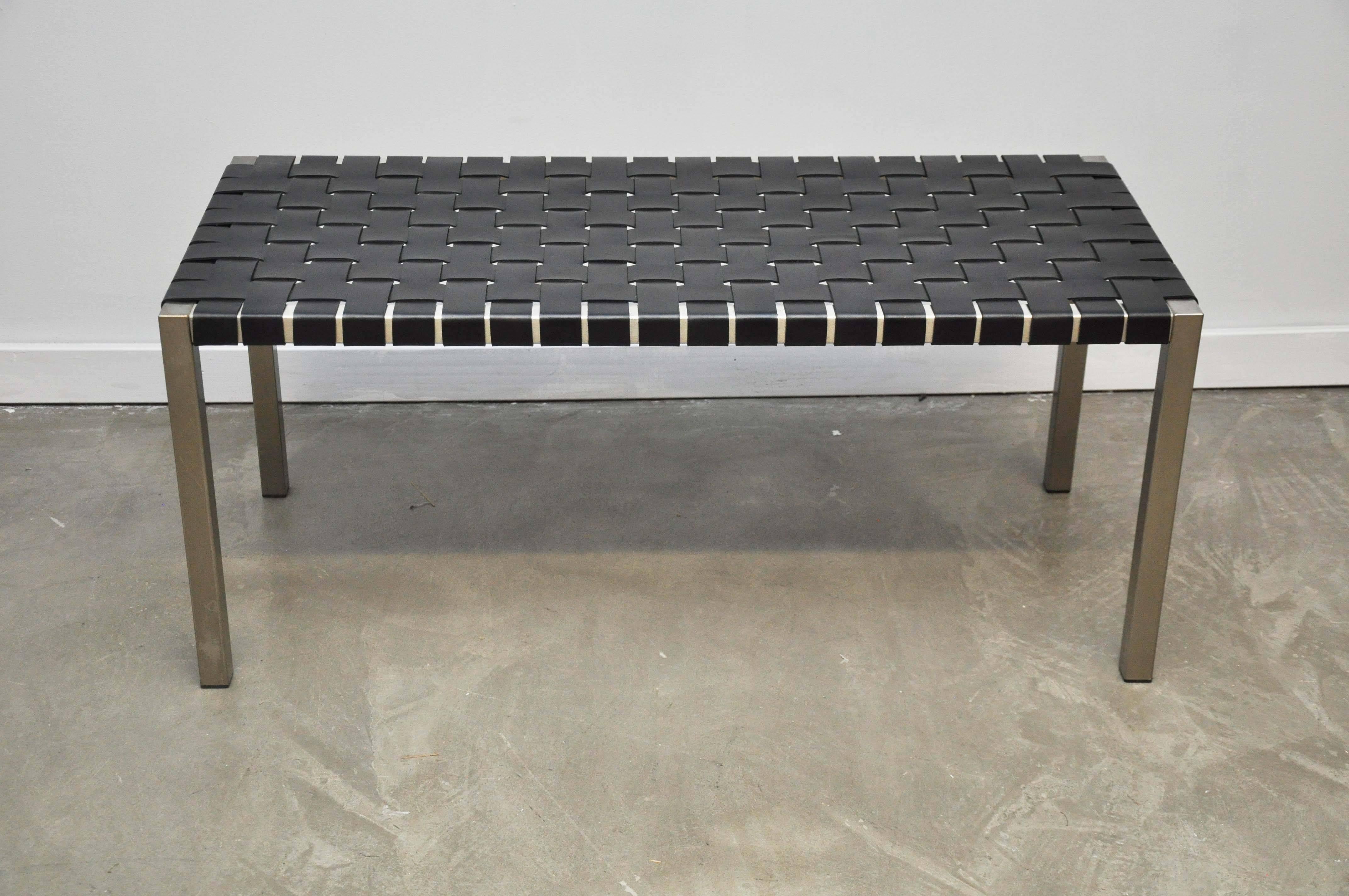 Steel frame bench with black leather strapping, circa 1970. New leather.