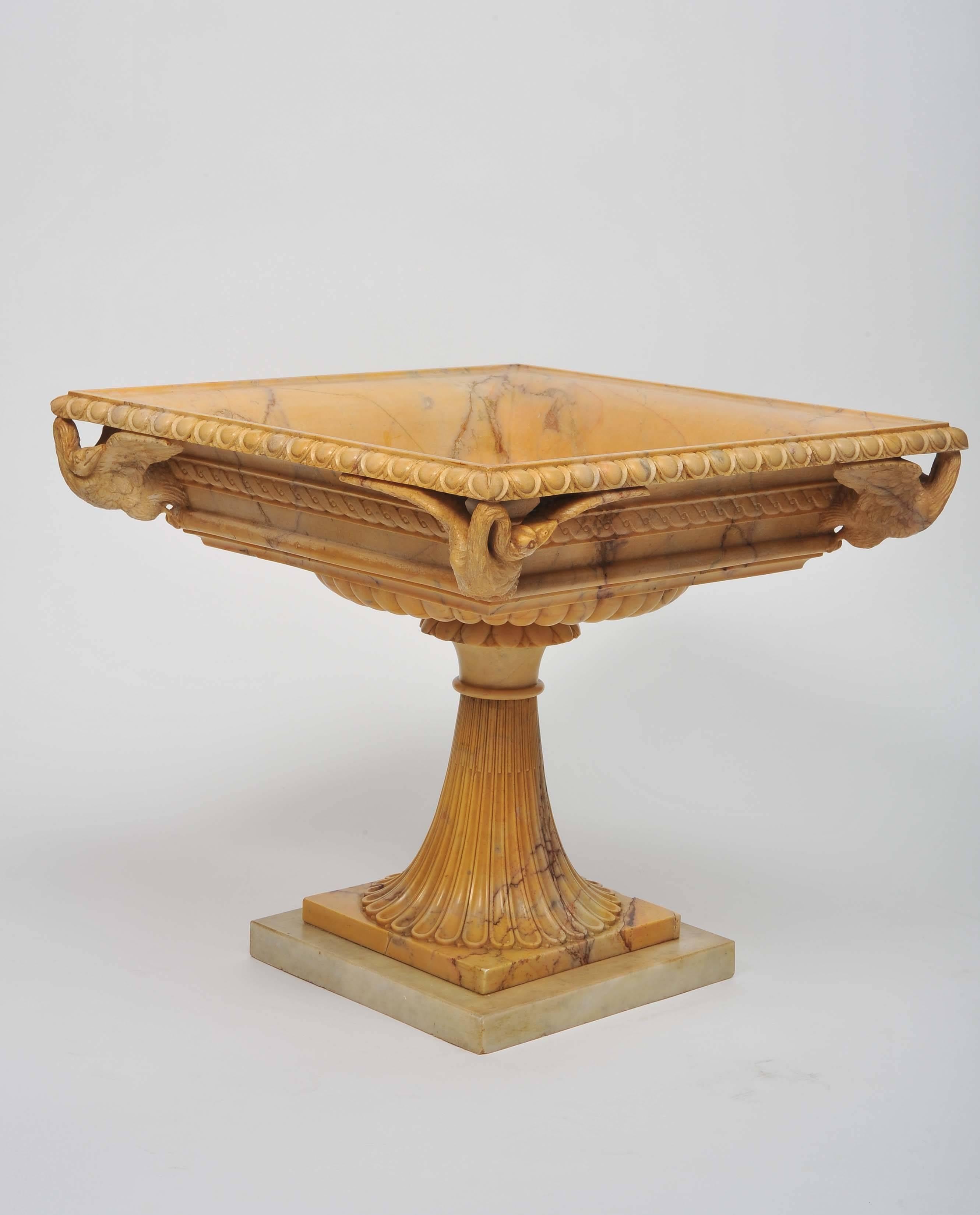 An early 19th century Grand Tour Tazza in Giallo Antico marble, the egg-and-dart rim above a guilloche band and four finely carved swans. On finely carved original socle base. With some later repairs.