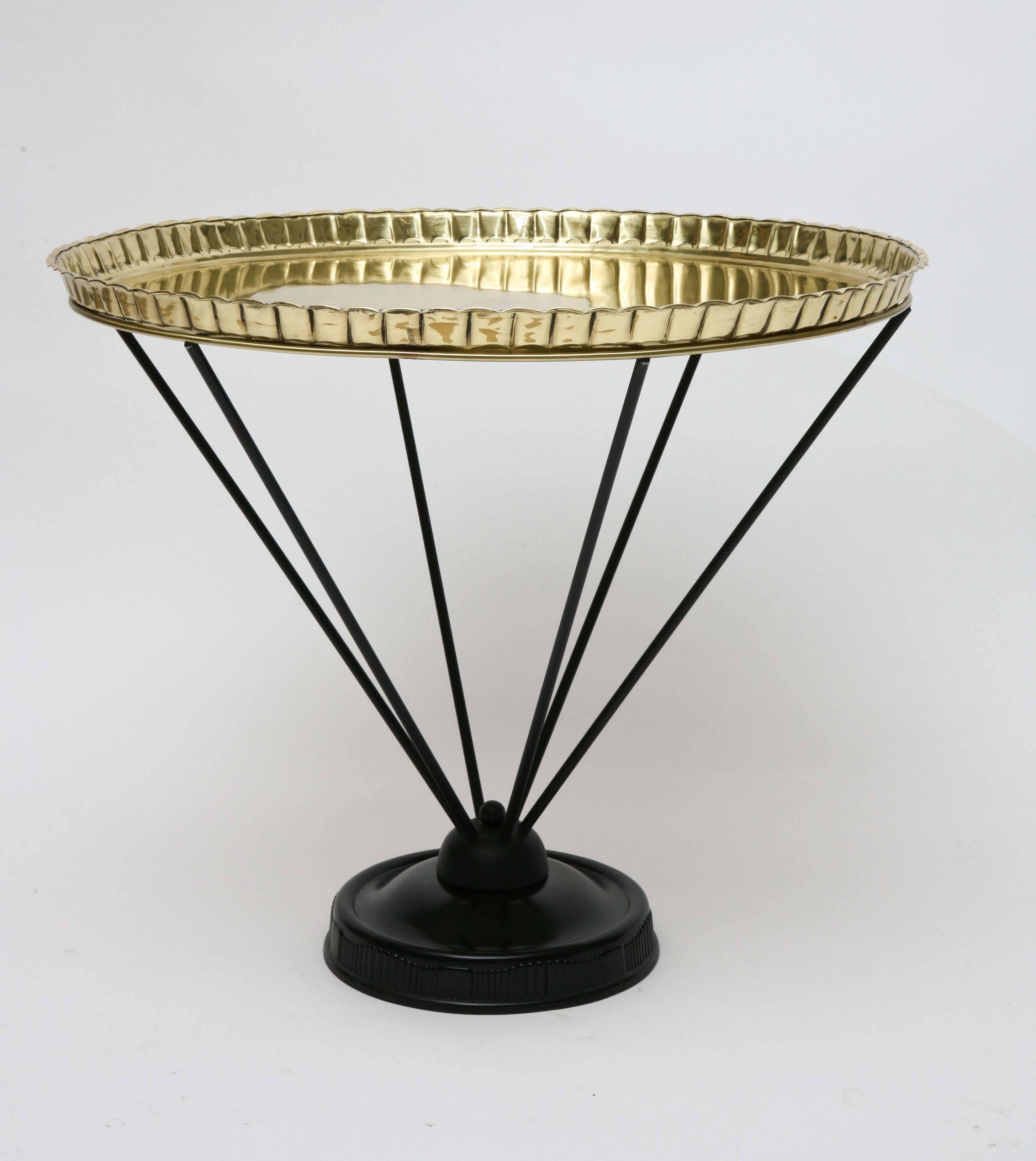 Inspired by Middle Eastern examples, this 1950s modernist table has a black enamel base and unadorned top in polished solid brass with a pie crust edge. Professionally restored.