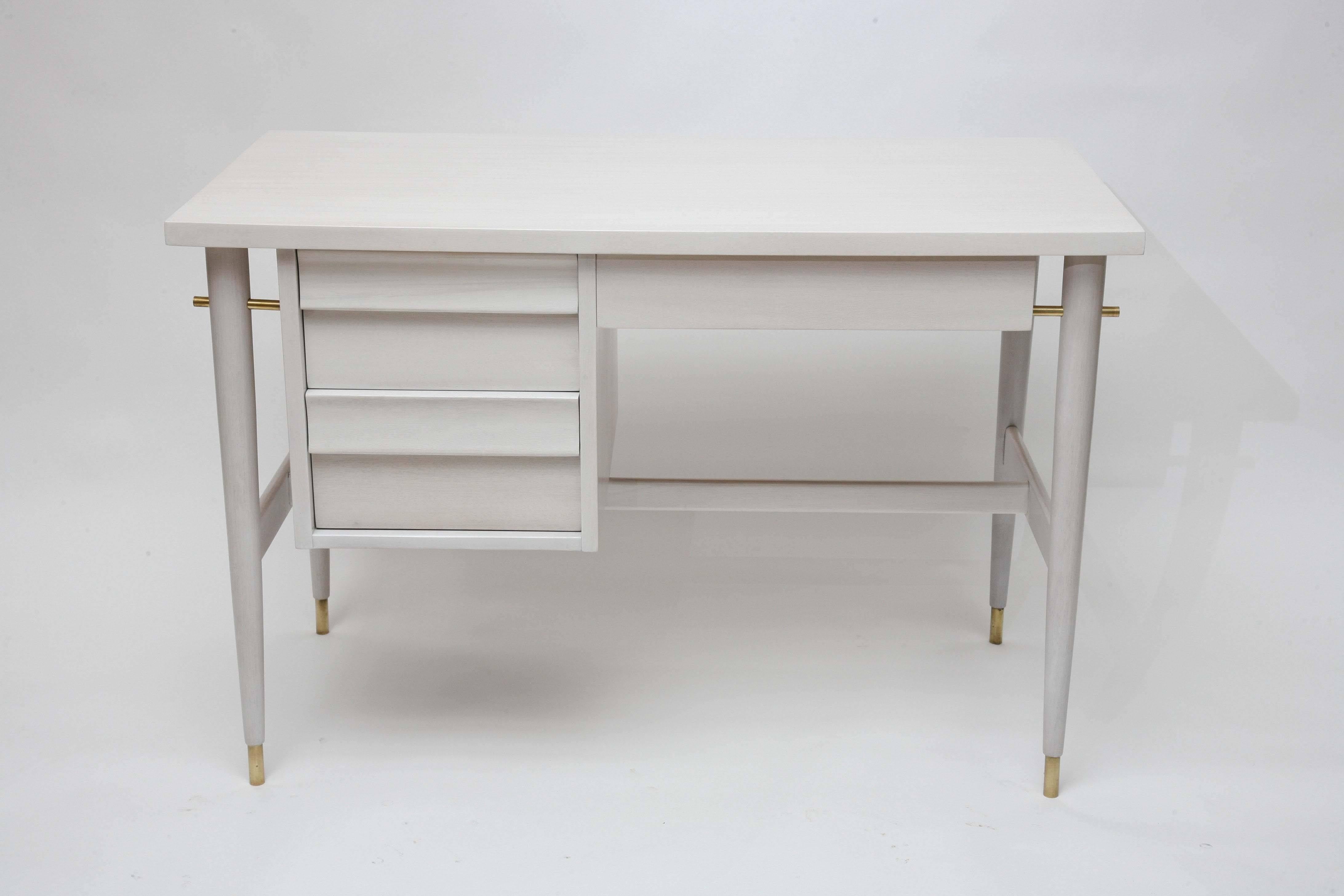 We've taken this superlative, clean-lined 1950s American desk in beautiful ribbon mahogany and bleached it an additional three times to obtain its wonderfully subtle coloring… a blend of palest cream and gray. Made richer still by the solid brass