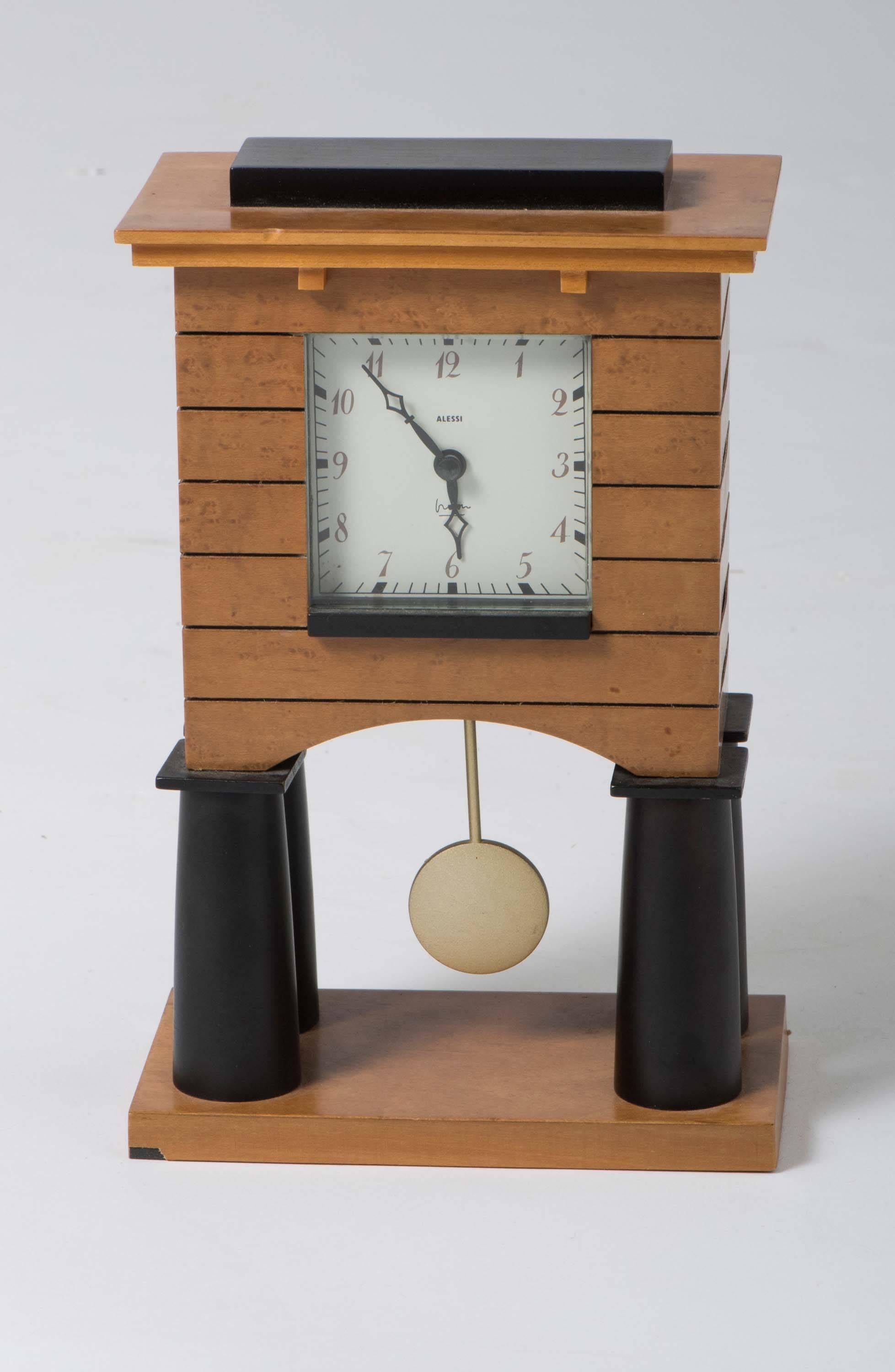 A mantel clock by Michael Graves for Alessi spa.
Birch, glass and metal,
Italy, circa 1988.
Measures: 25 cm high x 16 cm wide x 9 cm deep.
Lit ; Alessi, The Dream Factory, P60.
Design of the 1980s, p.222.
 
