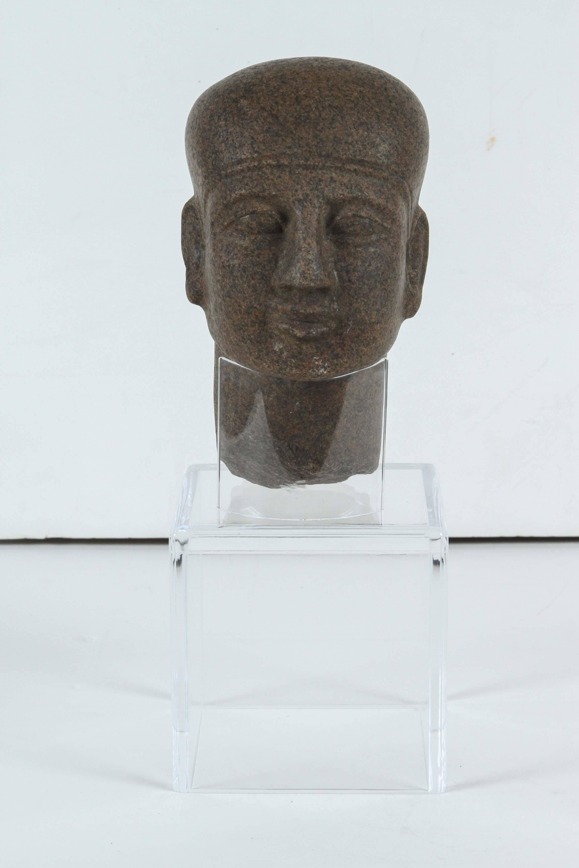 Beautifully carved, granite head of a priest mounted on a custom, Lucite base.