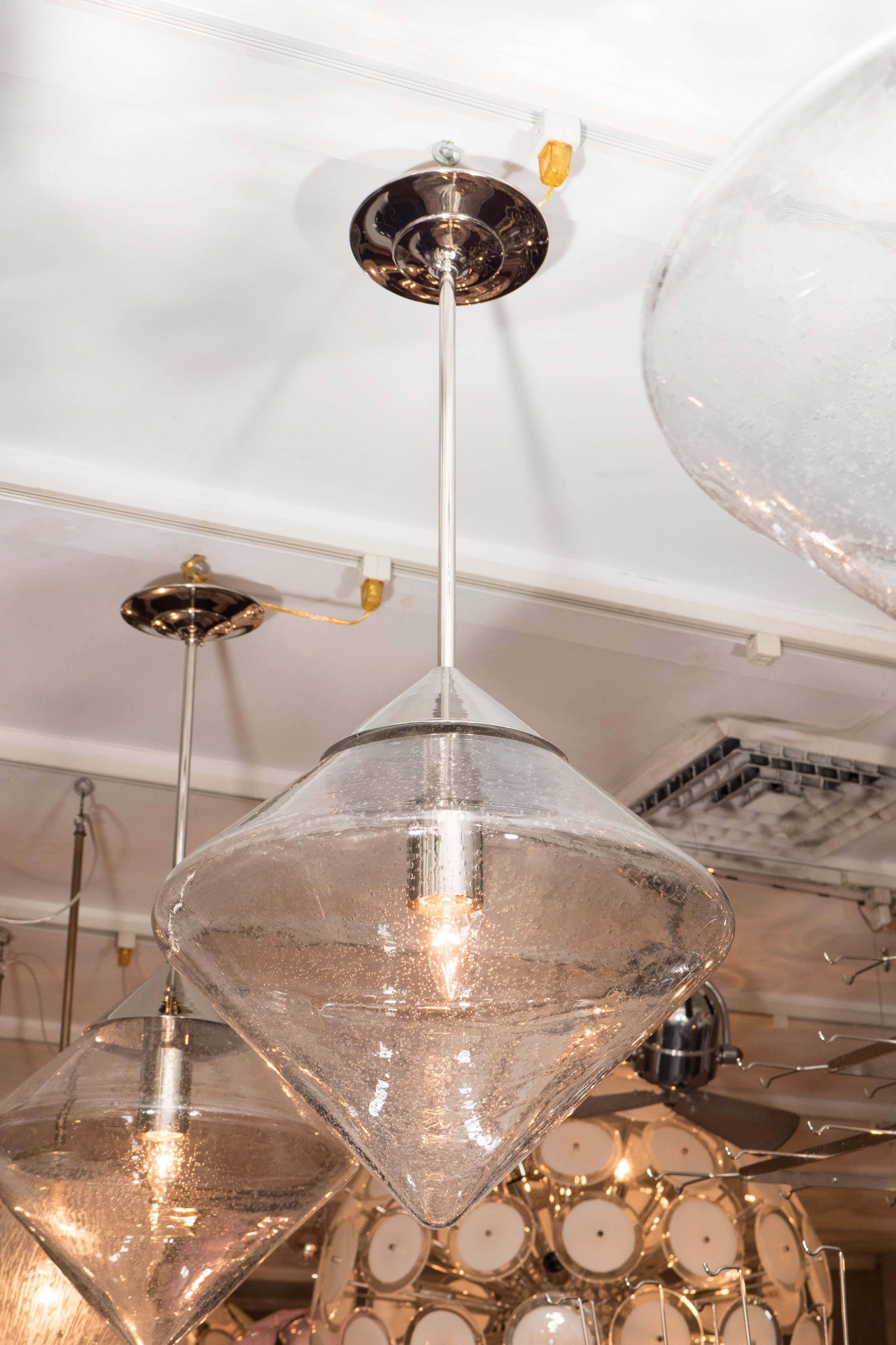 Pendant with Prism Globe and polished nickel finish rods and canopy.