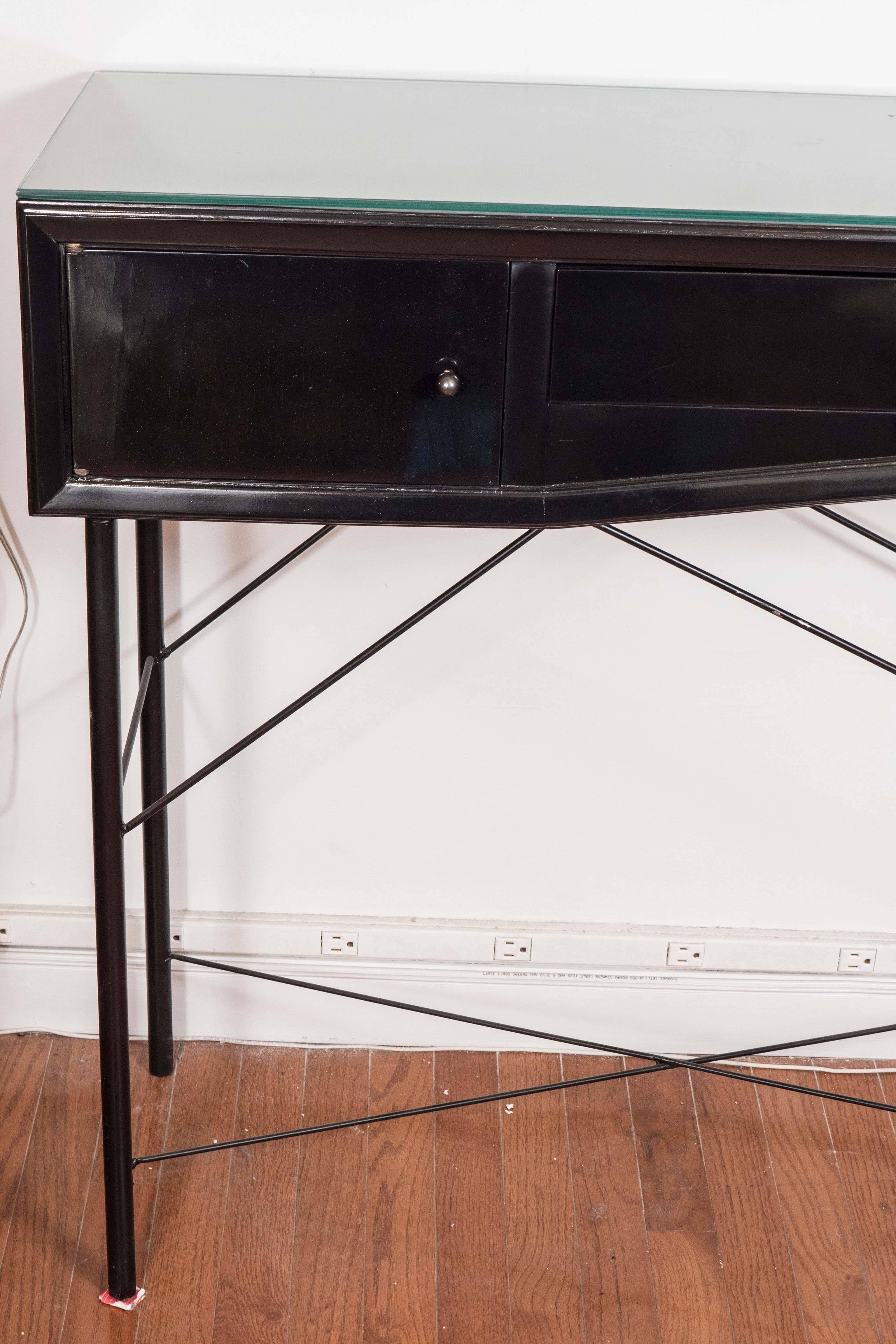 Lacquered wood console table with iron base featuring a storage compartment and single drawer with whimsical foot form pull.