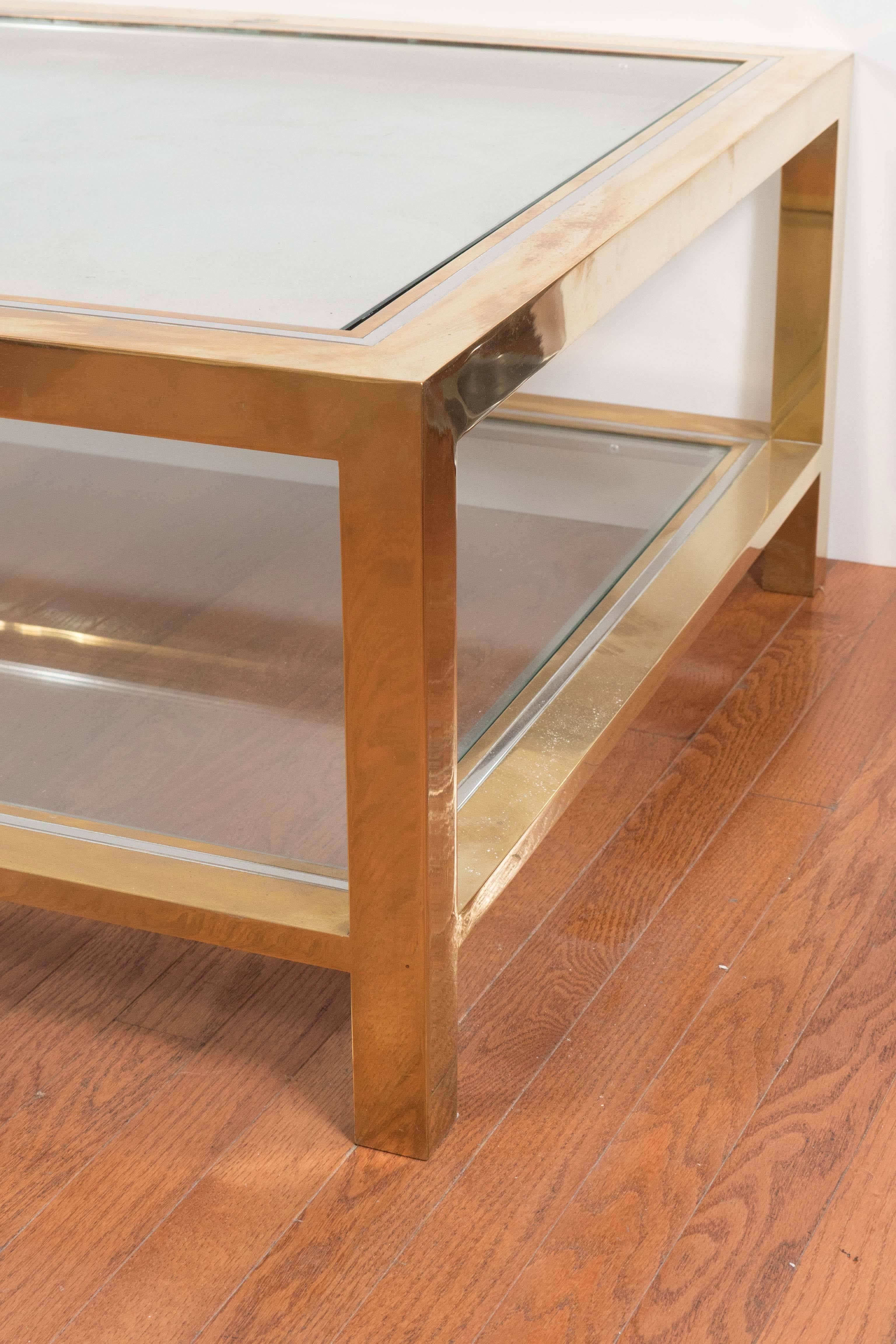 Two-tier brass coffee table with nickel trim and glass tops by Willy Rizzo.