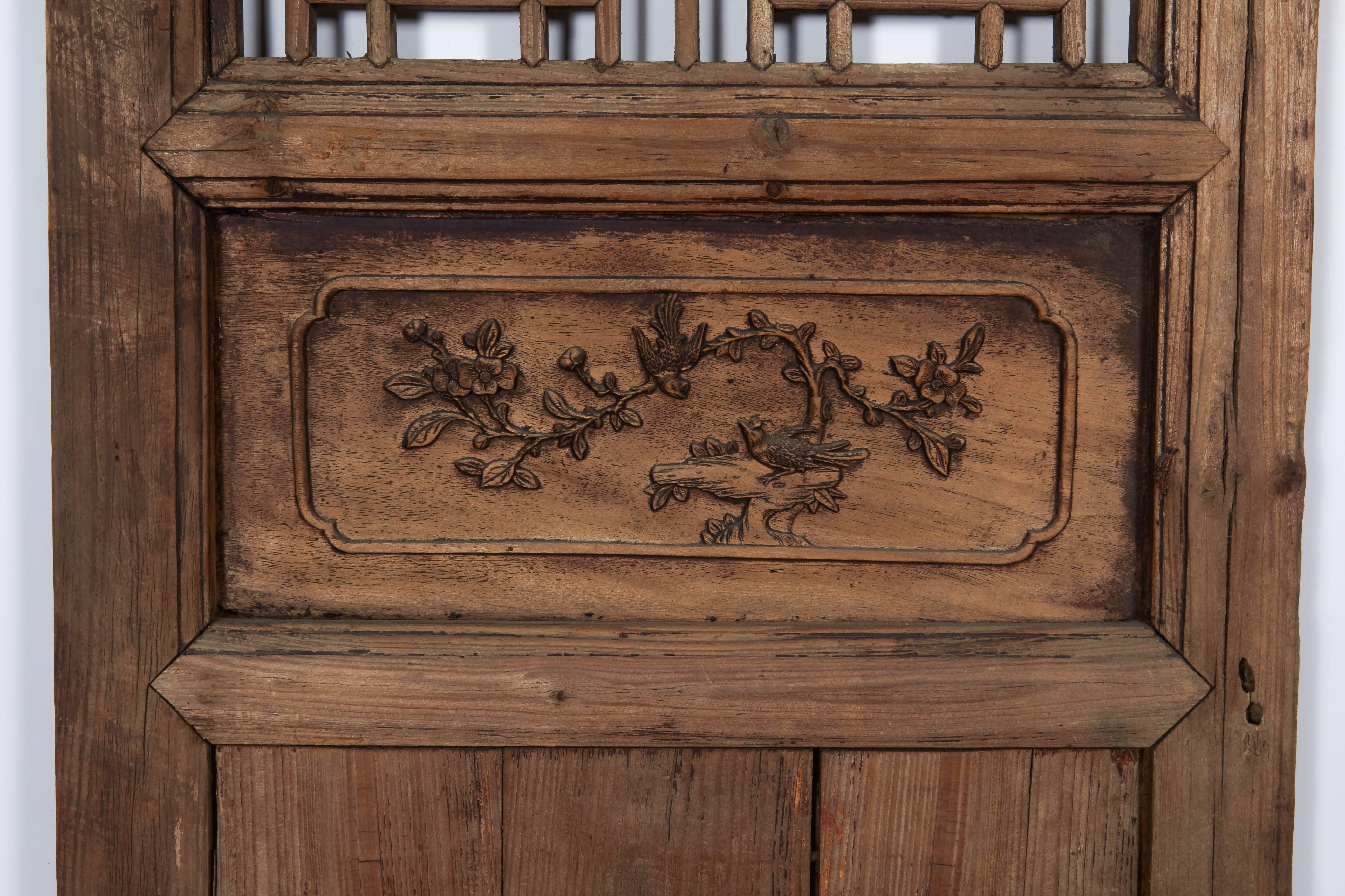 A tall antique Chinese window screen with geometric central pattern and fine carvings above and below. From Shanxi Province, circa 1850.
P385.