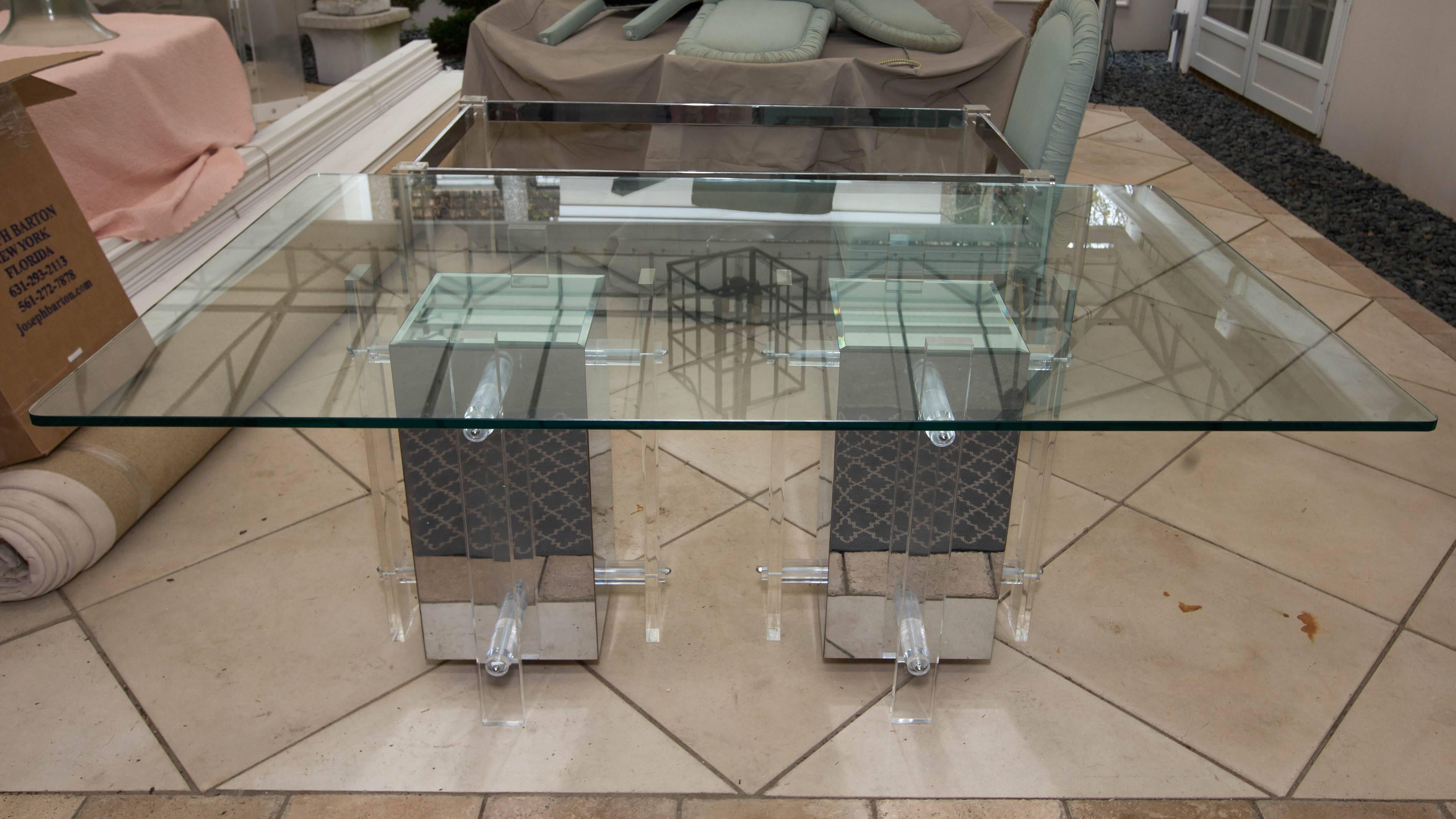 Very attractive and unusual Mid-Century dining table with glass top and pedestal base. Each pedestal is Lucite and mirror and measures 20 x 20 x 29 H.