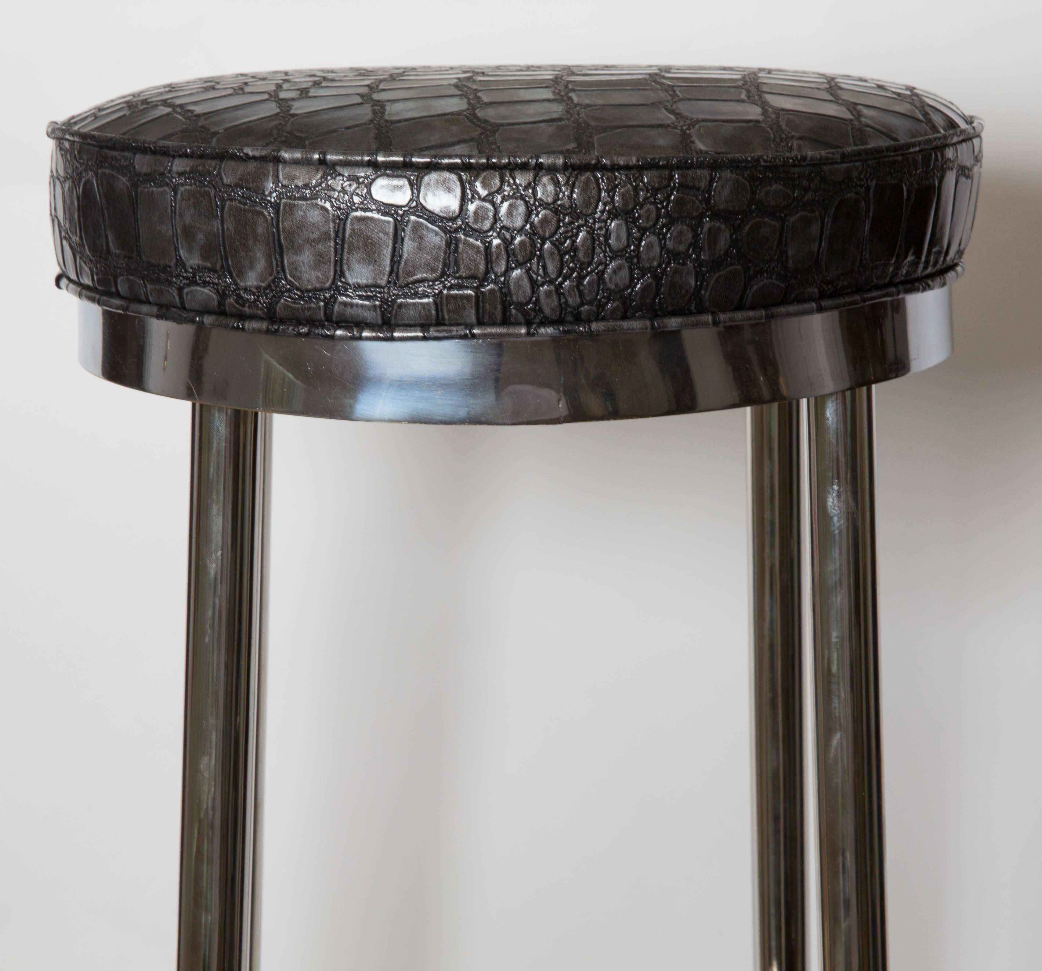 Set of four chrome bar stools upholstered in black and grey faux crock.
