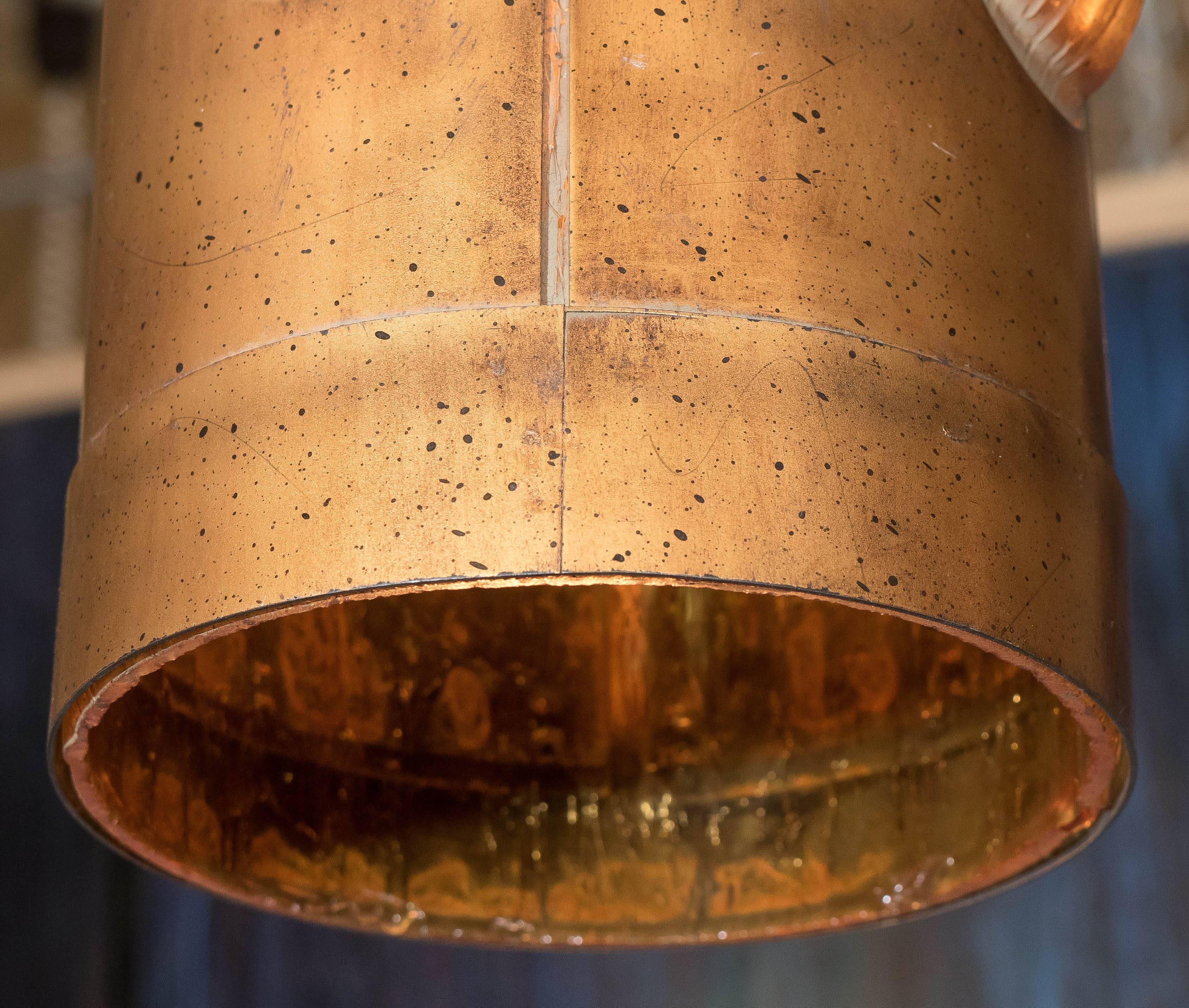 This hanging light pendant, produced circa 1960-1970, comes with cylindrical shade in gilt metal, with amber toned resin detailing. Wiring to US standard. Very good condition, consistent with age and use.