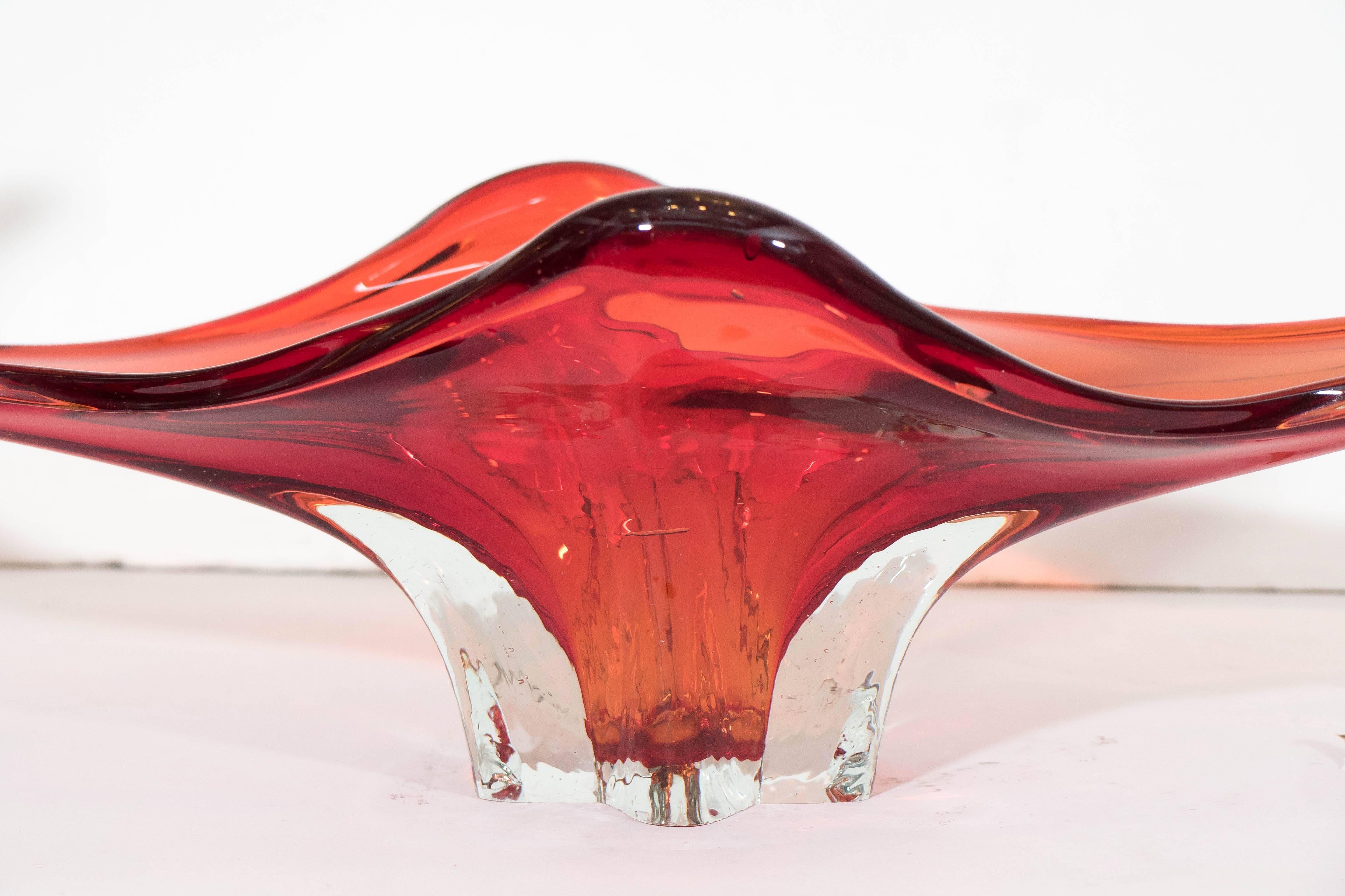 This decorative bowl and centerpiece, produced circa 1960s, comes in orange Sommerso Murano glass, rendered into a highly abstract, organic shape. Very good vintage condition, consistent with age and use.