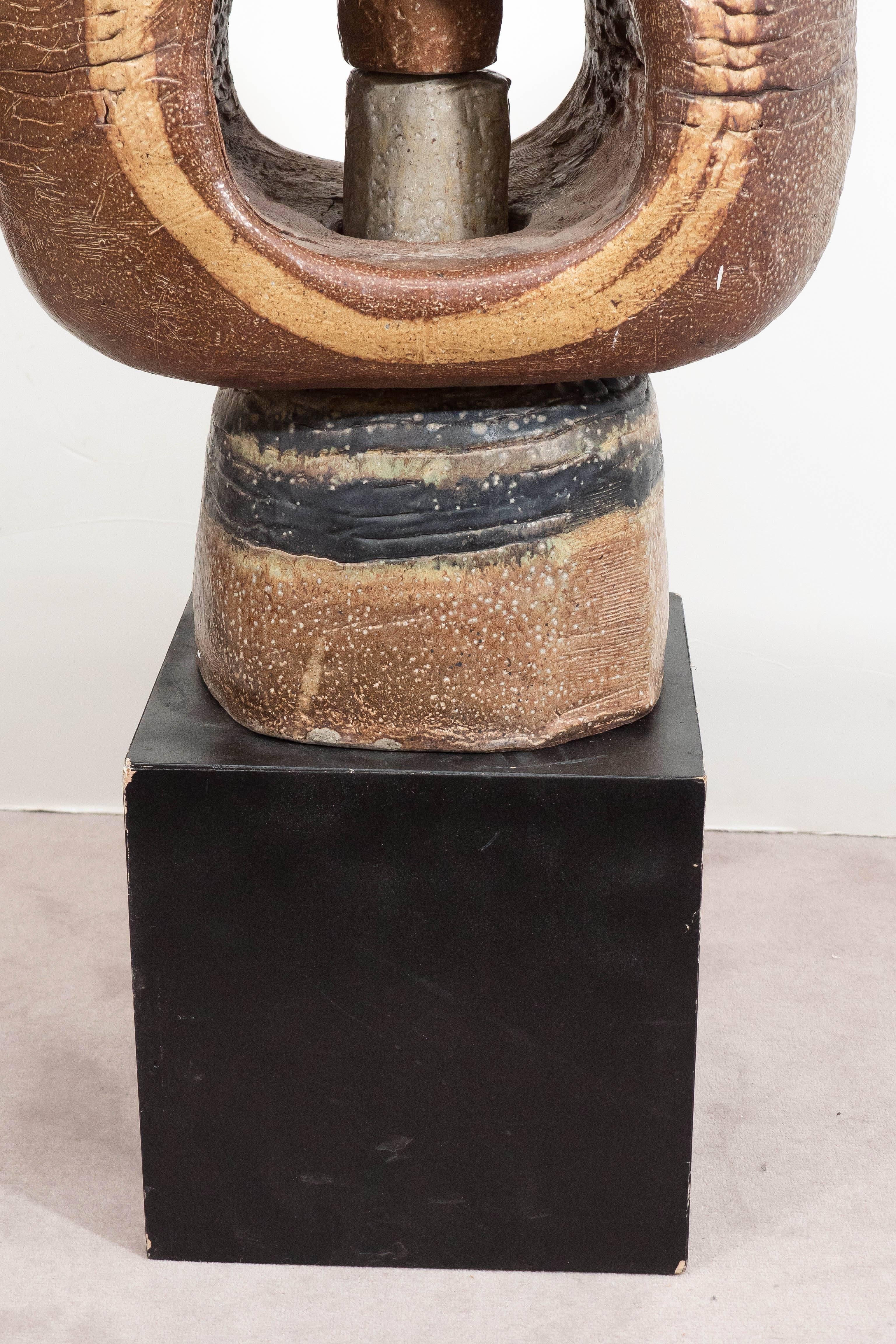 This circa 1970s sculpture by East Hampton artist Phyllis Hammond, depicts a highly unique abstract form in multi-toned clay; detached from base. Markings include [Phyllis] to the base. Despite some presence of wear to base, including minor chips