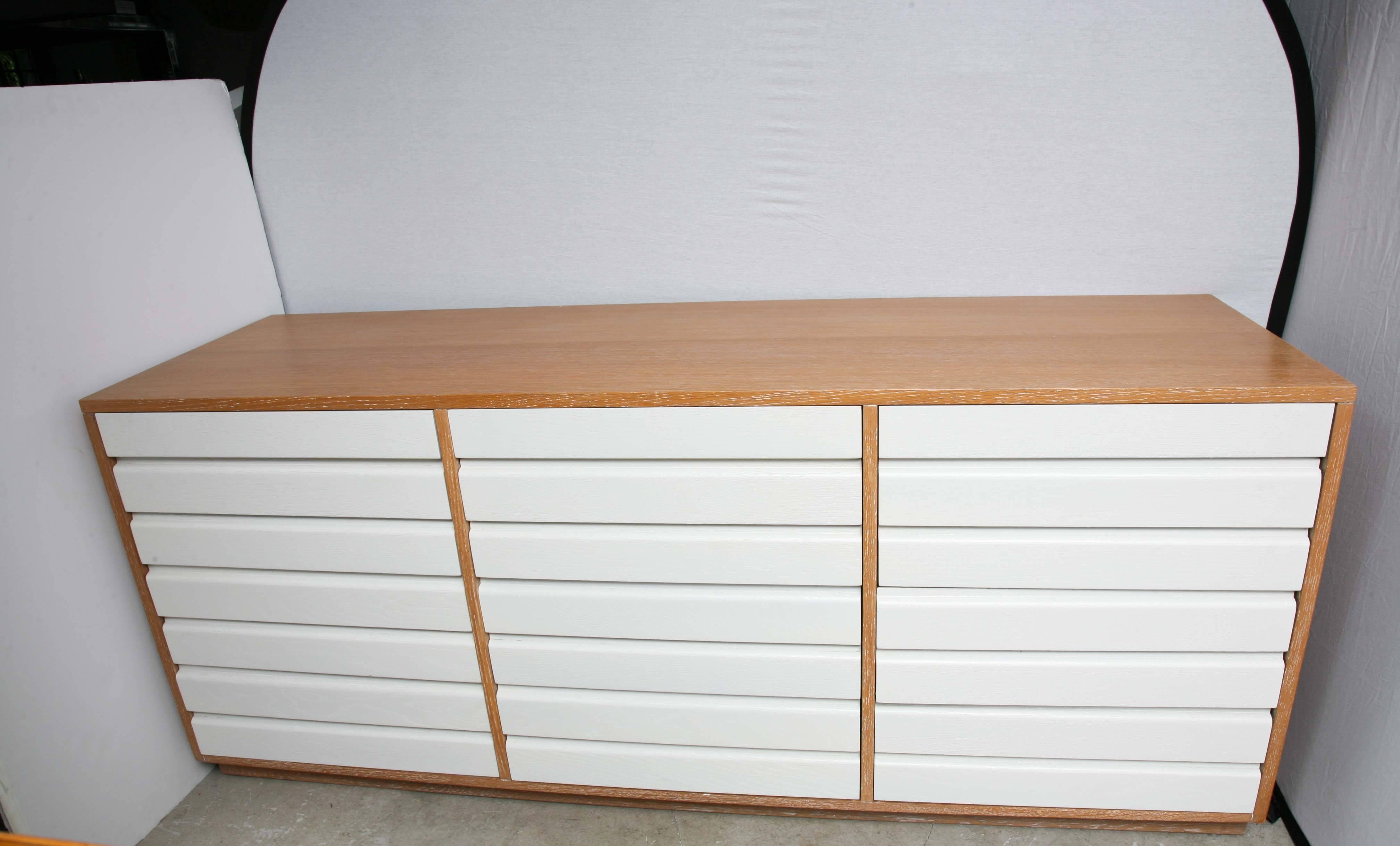 Oakwood construction with a cerused finish and 12 painted white pull-out drawers. Cabinet has been refurbished.