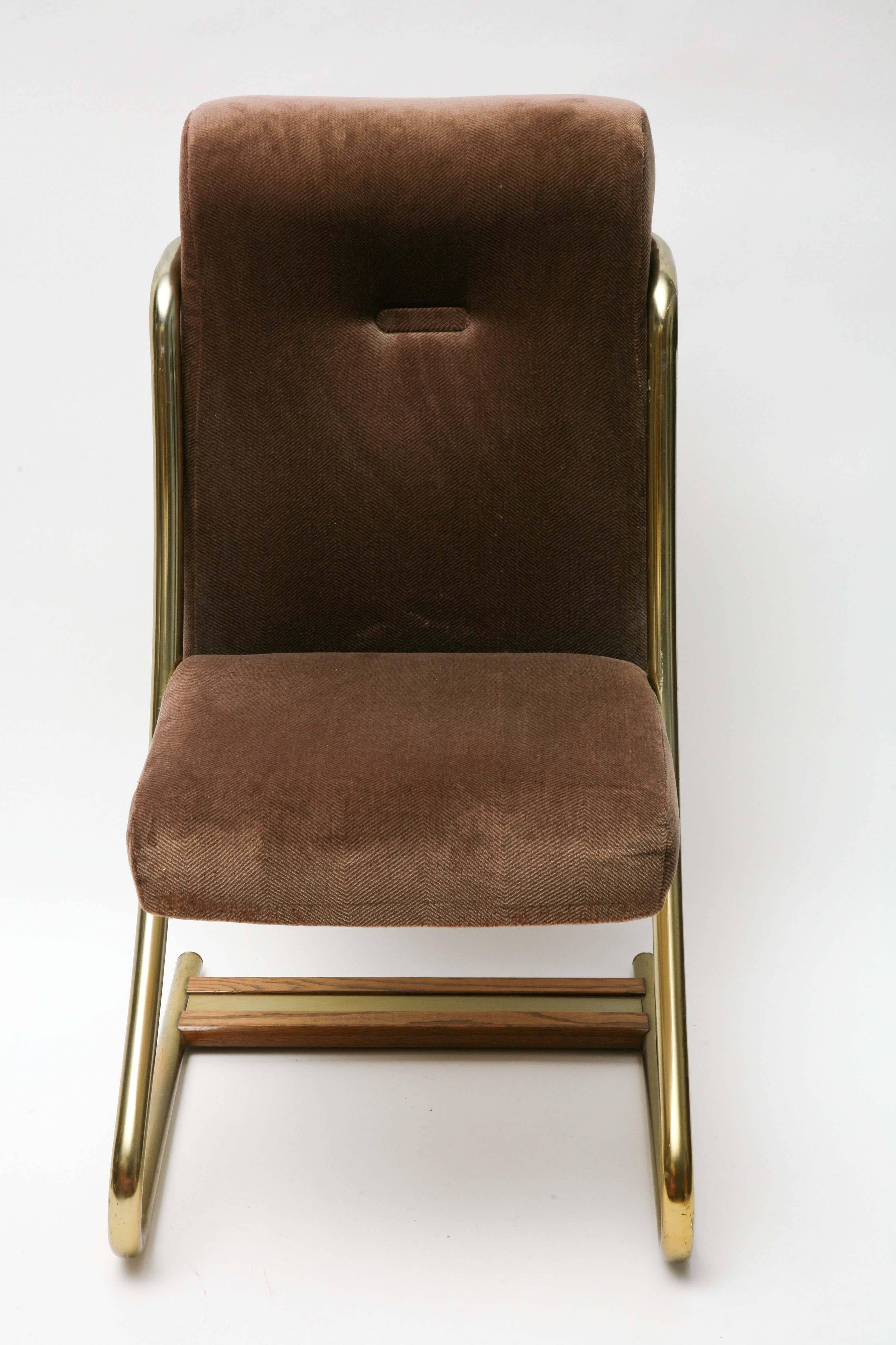 Upholstered chairs with brass frames and wood and brass support accents across the bottom. Chairs made by Daystrom furniture company.