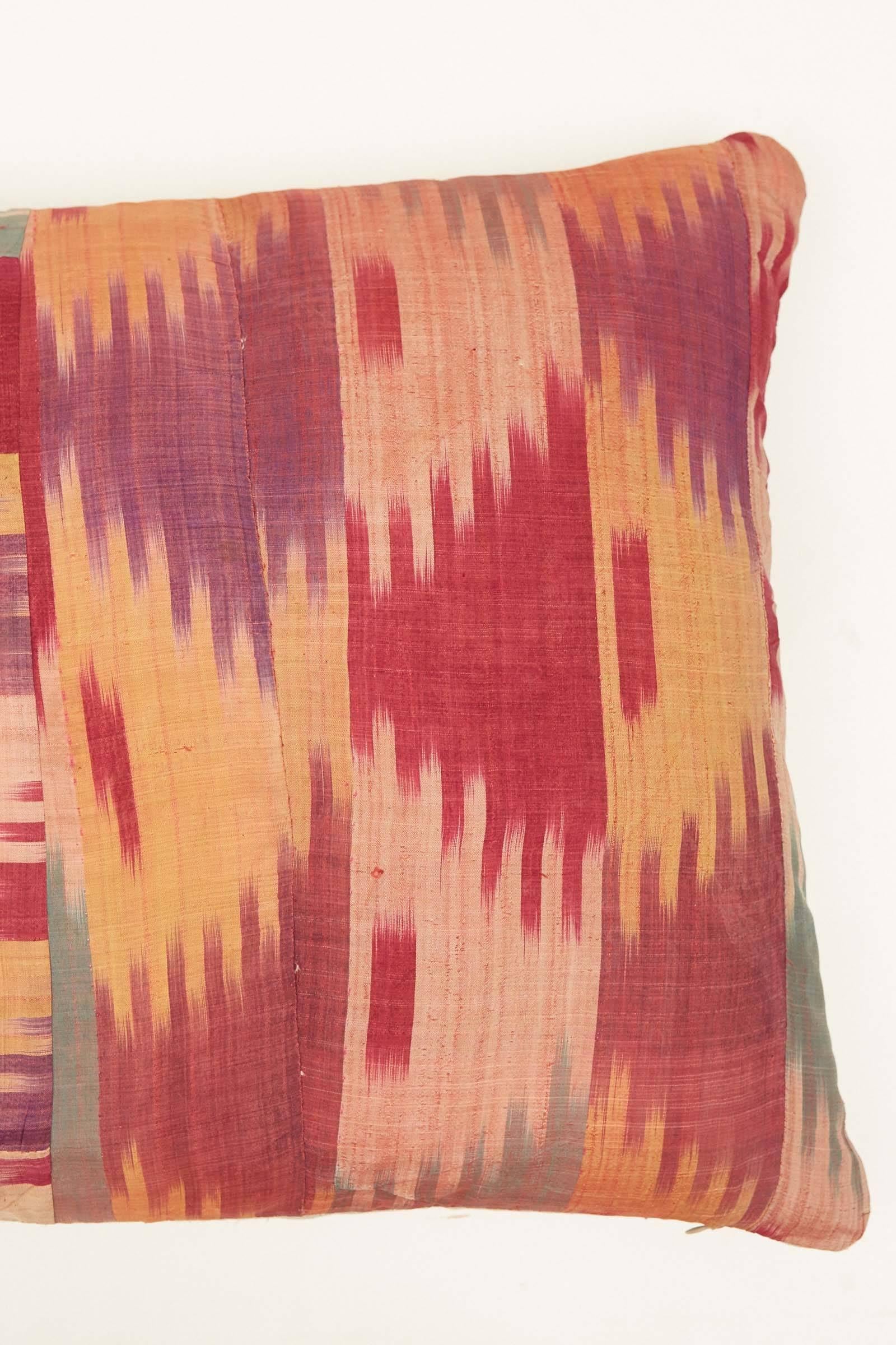 Mid-Century Afghani silk Ikat strips sewn together. Red, turquoise, gold, purple and pale pink. Natural linen backs. Invisible zippers. Feather and down fill. Measures: 19 x 26.