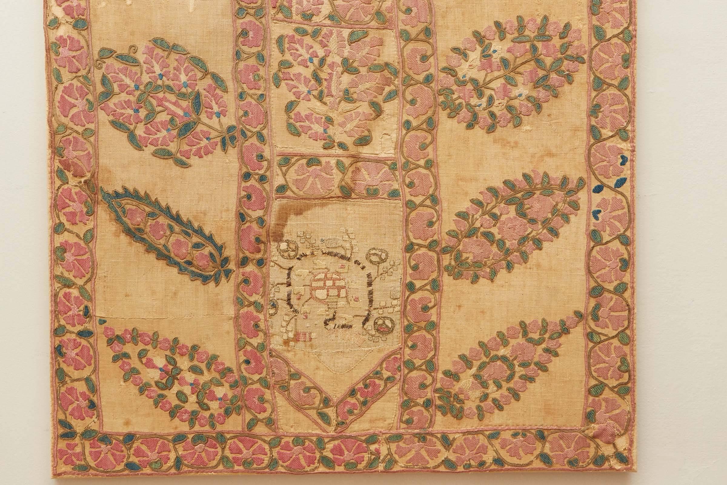 Susani has been backed and mounted on a wood stretcher. Silk embroidery on hand woven linen. This is an early piece with quite a bit of distressing, some staining and patched areas. The patches are antique ottoman textile fragments. Very interesting
