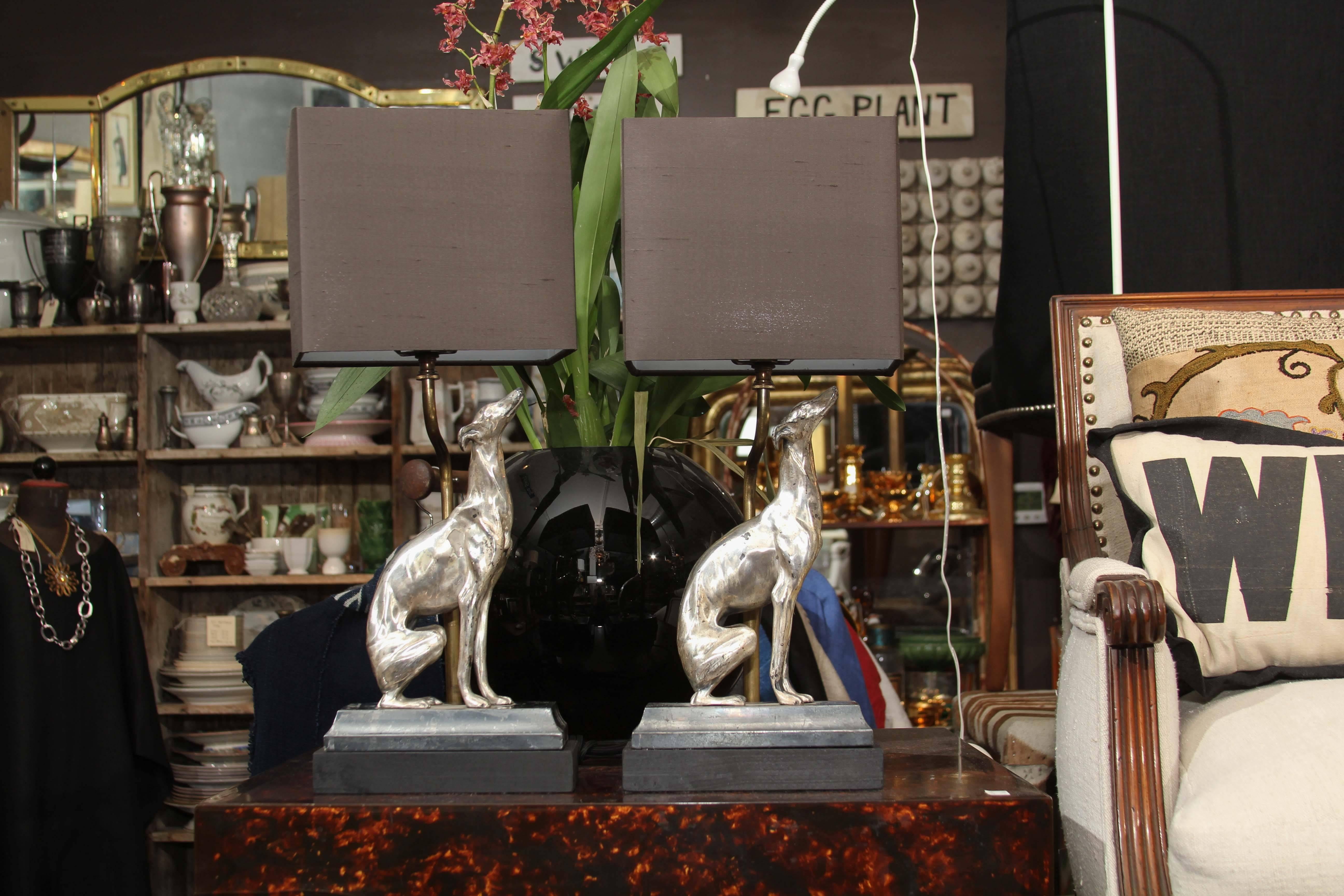 Lovely pair of custom silver plate dog lamps. Museum mount with adjustable arm topped with black silk shades.