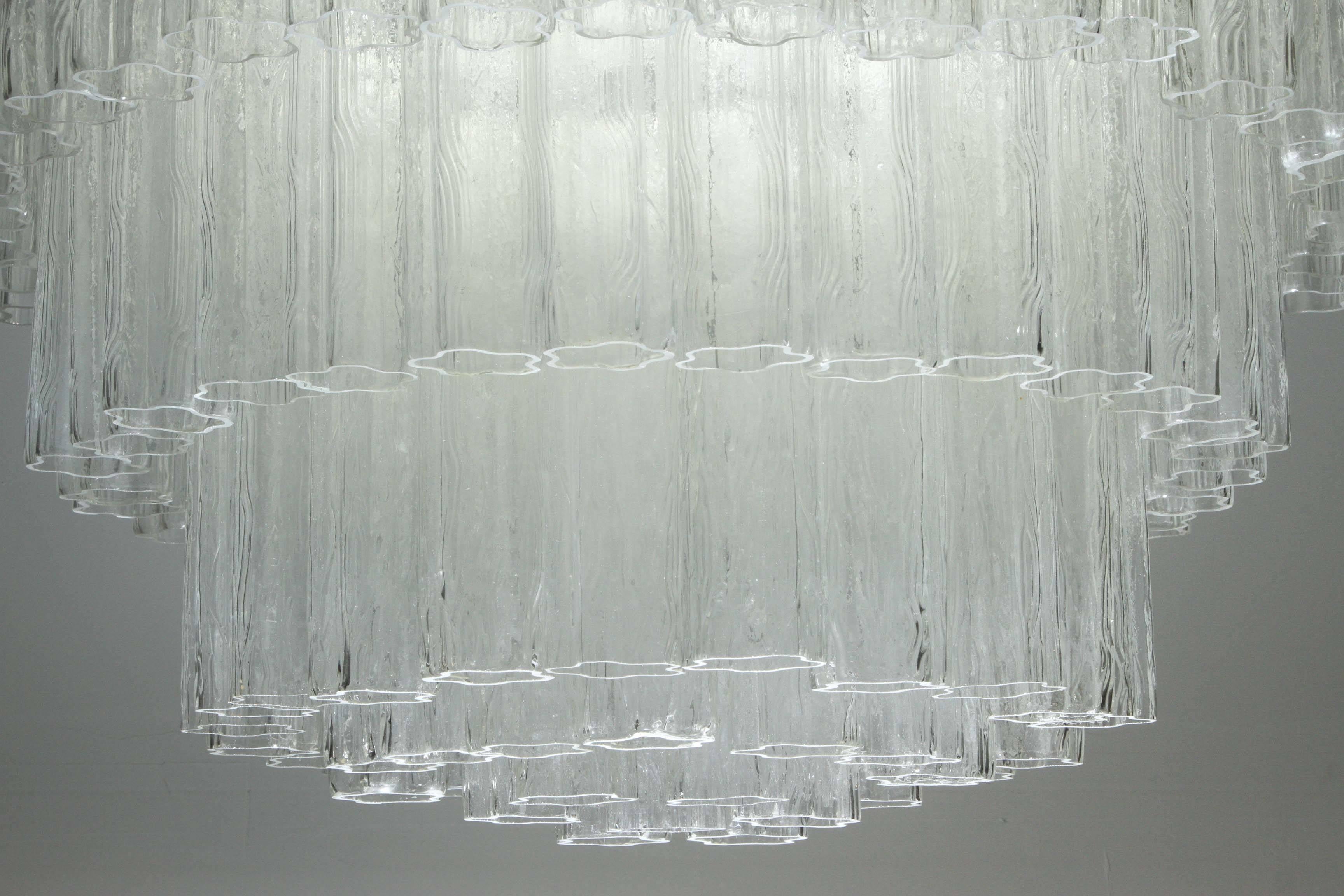 Large five-tier Tronchi tube chandelier by Camer Lighting Company.
The polished chrome armature supports 110 large clear glass tubes which have a slightly textured effect to create an impressive "ICE" like effect chandelier.
It comes