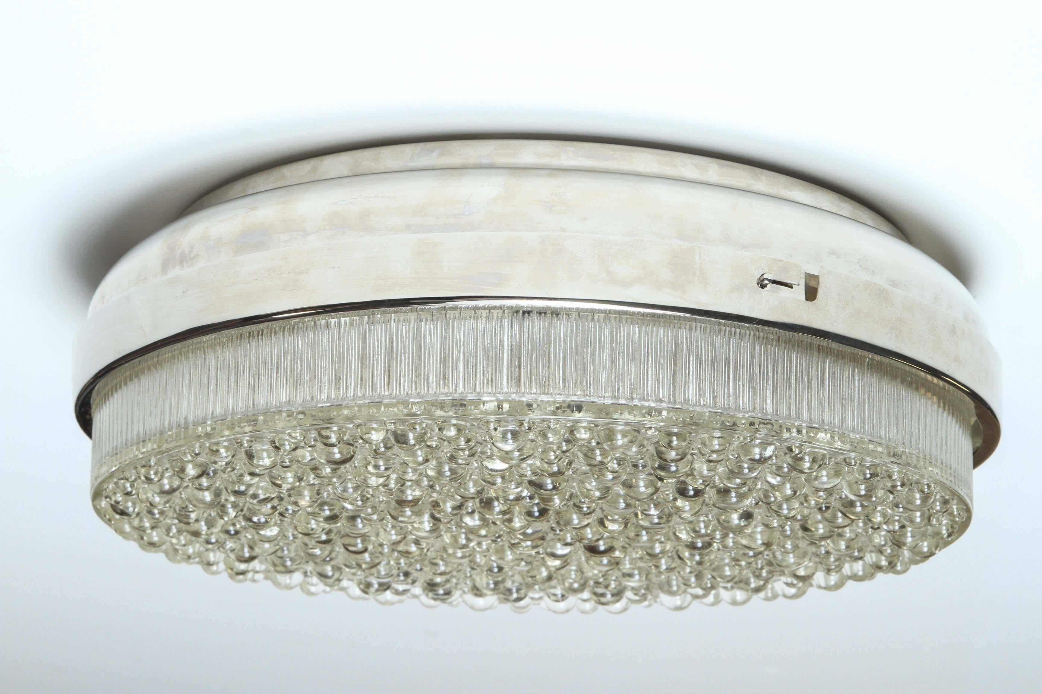1960s German bubble glass ceiling fixture/sconce.
The textured bubble glass is supported by a polished chrome frame and has two newly rewired light sources.