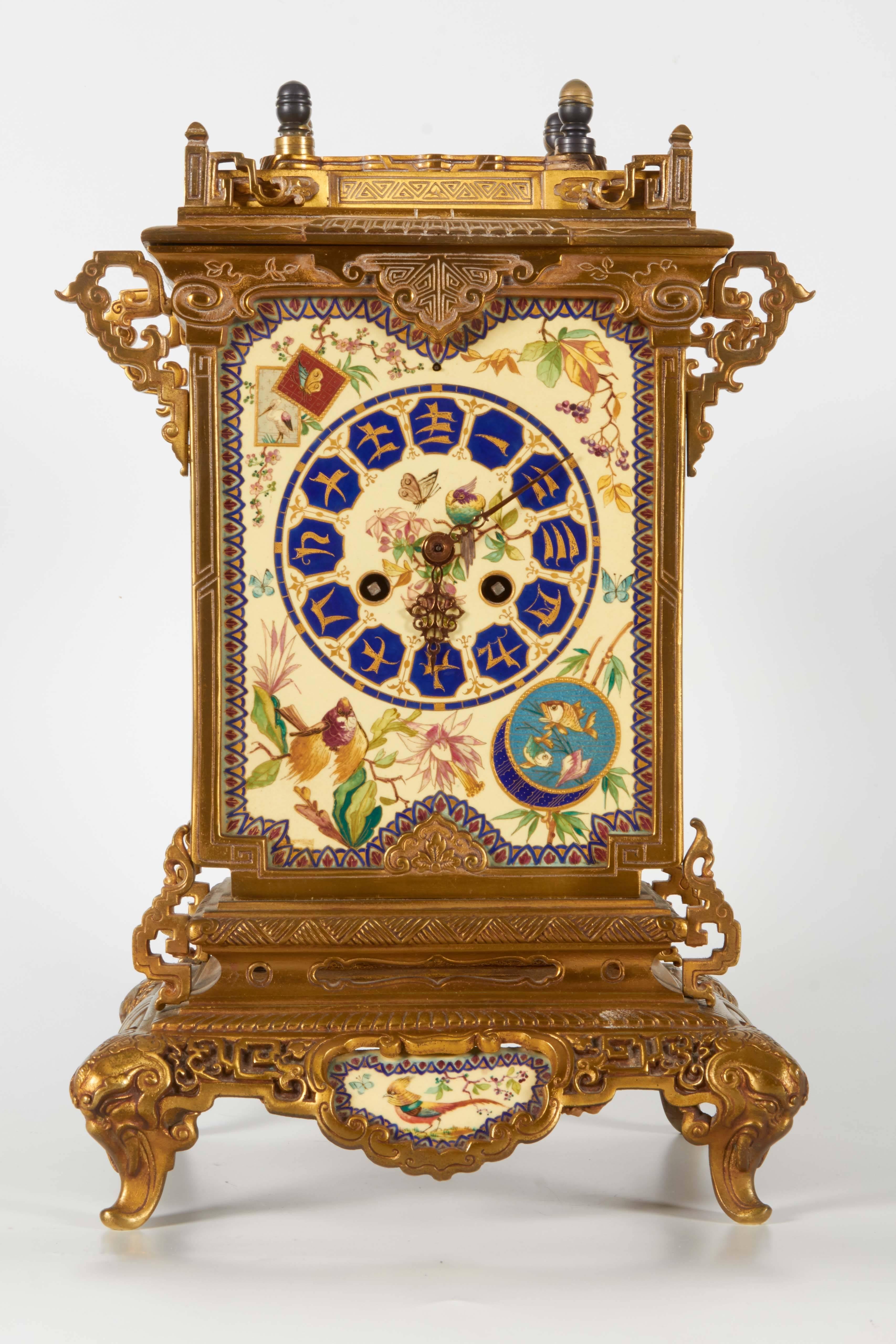 A very unusual and quite rare 19th century French chinoiserie/Japanism dore bronze mounted and hand painted porcelain aesthetic movement clock, attributed to E. Lièvre, most probably cast by F. Barbedienne. This clock is expertly designed by the