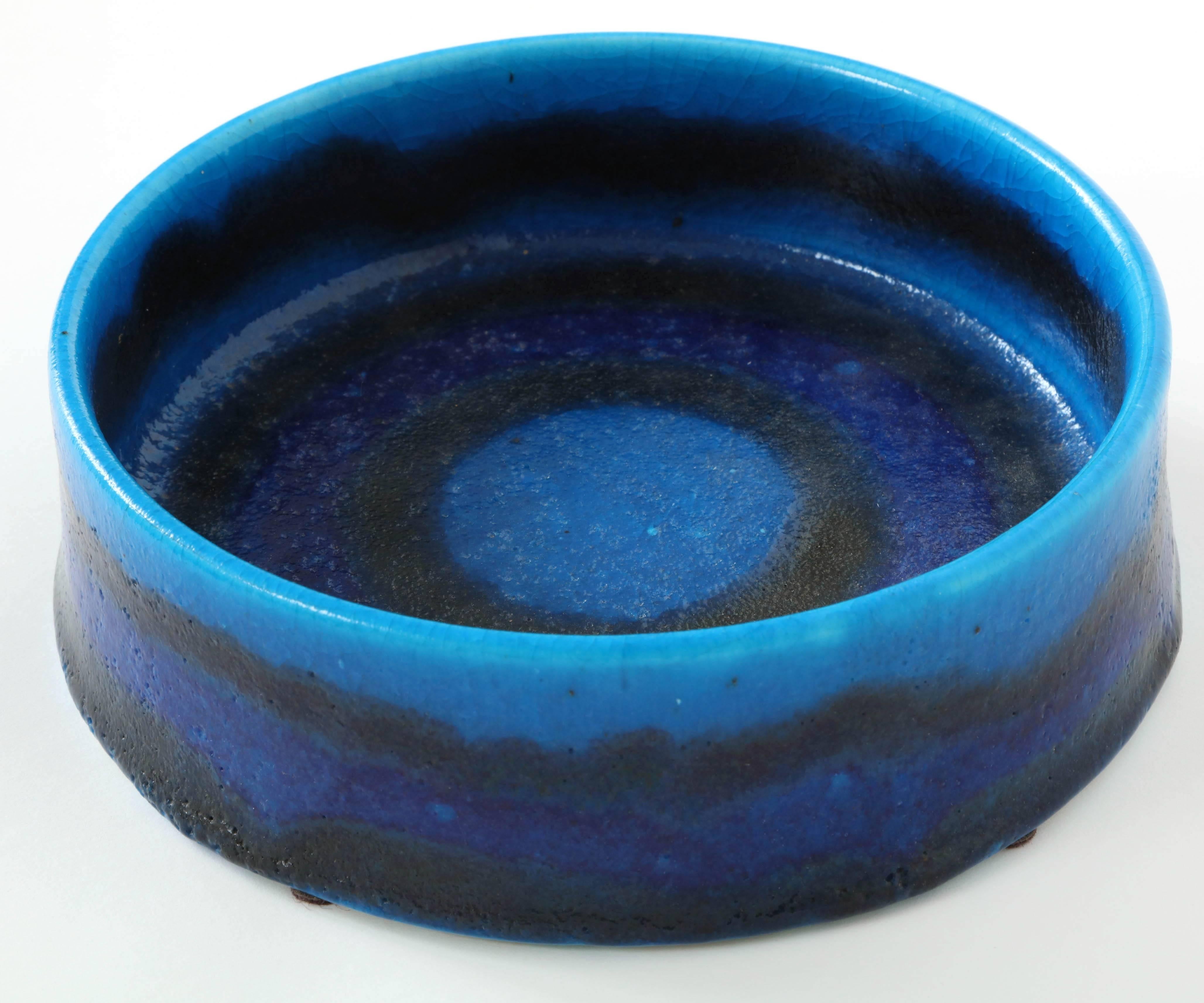 Cylindrical bowl painted in thick concentric rings of varying shades of blue. Great depth of coloration. By Bruno Gambone, 1970s, signed on underside.