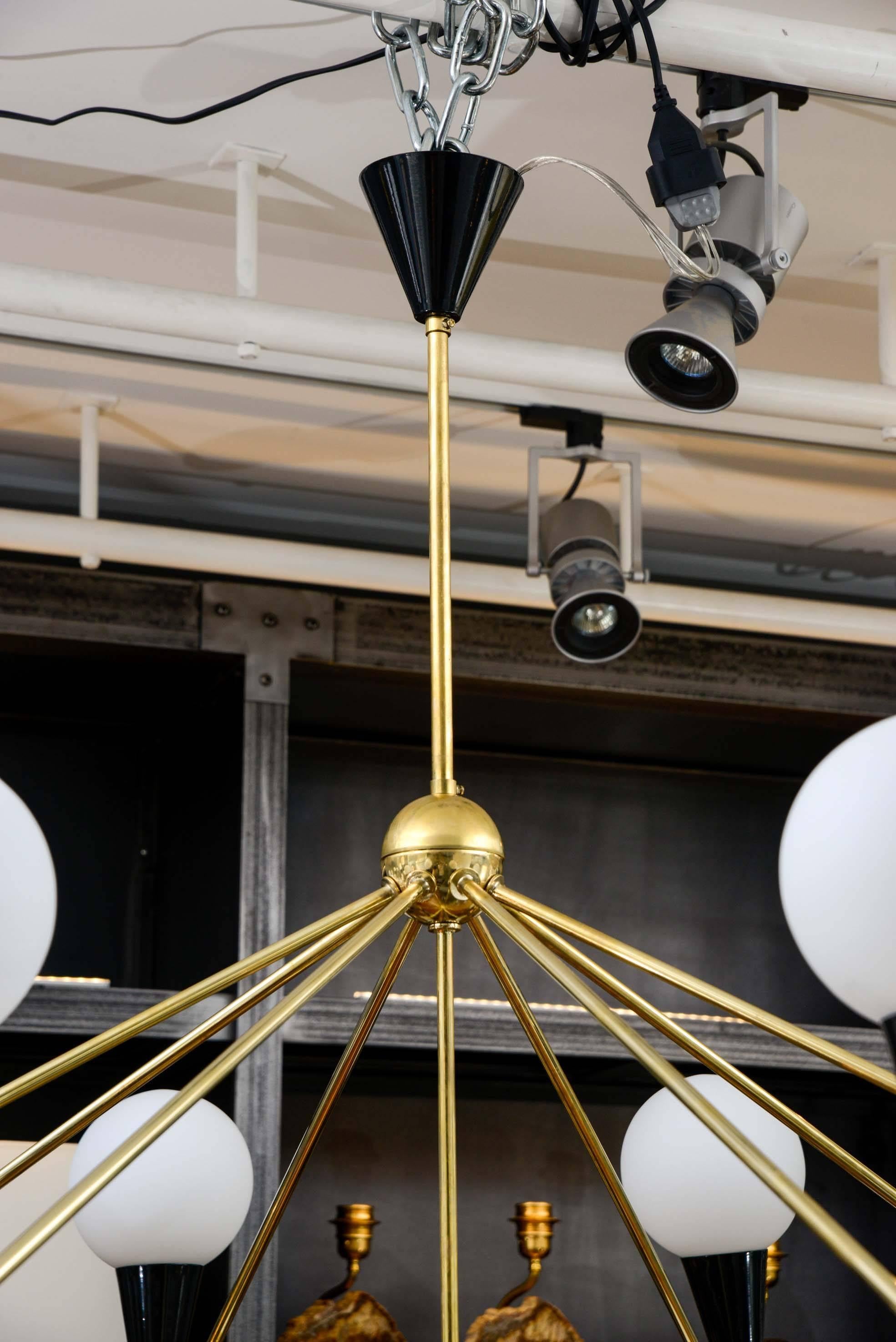 Mid-Century Modern Wide Symmetrical Pair of Brass Chandeliers with Globes