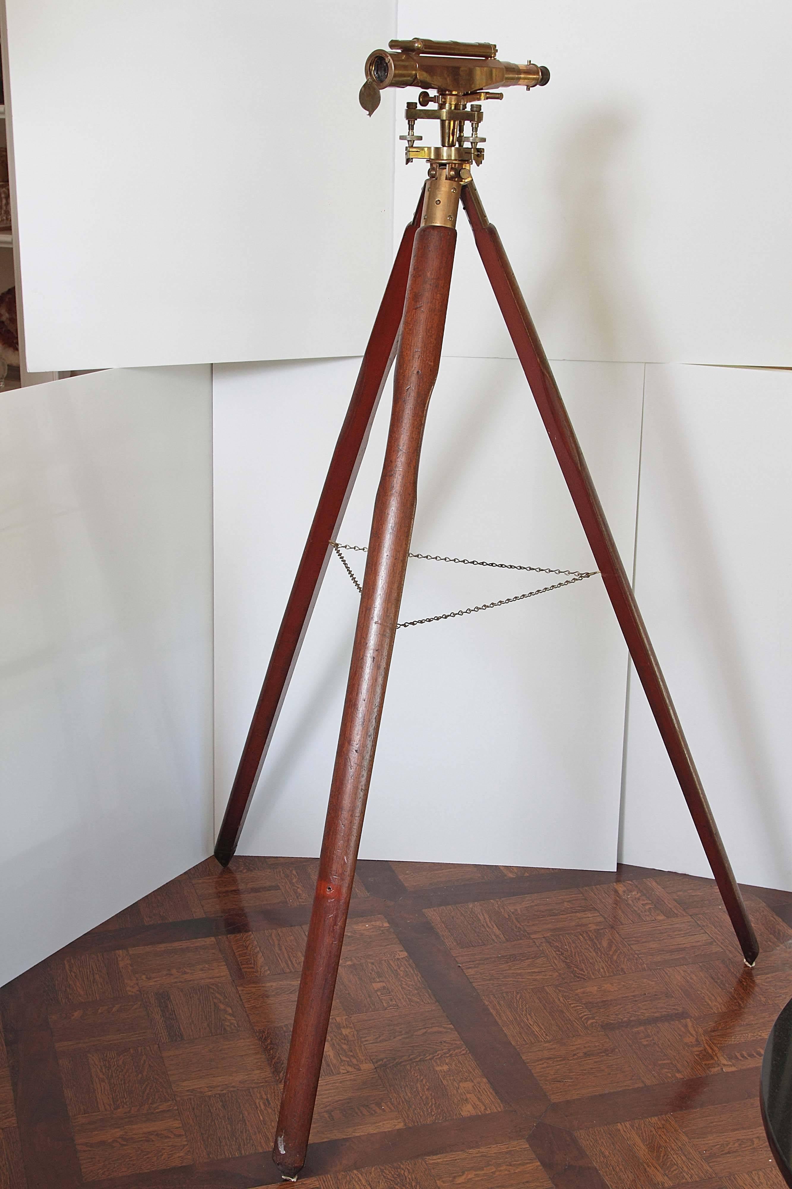 Solid brass surveyor instrument by A.G. Thornton of Manchester on wooden tripod. Trademarked Stanley London, 28750. Made in England.

Tripod measures approx. 62