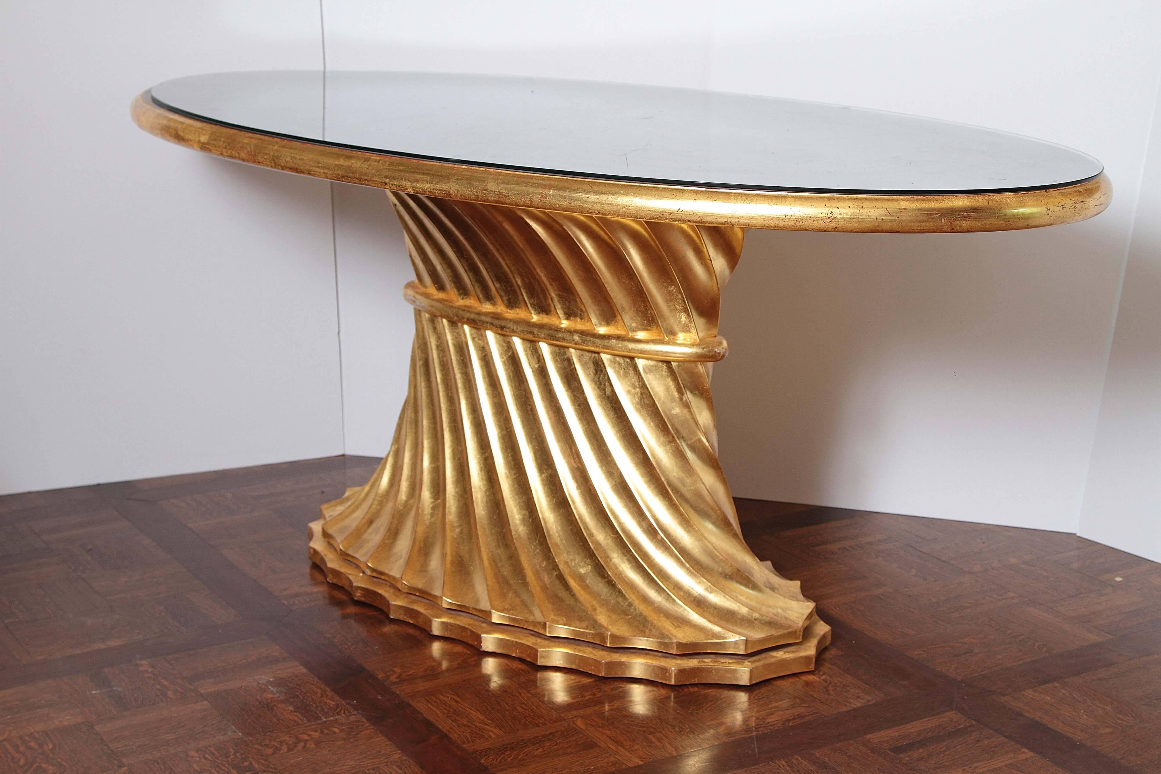 This is a limited edition table custom-made by award-winning furniture designers Sherry Hayslip and Michael Stallings. The top is made of solid walnut with 24-karat gold and water gilding on the broad bull-nose edge. The base is carved in a twisting