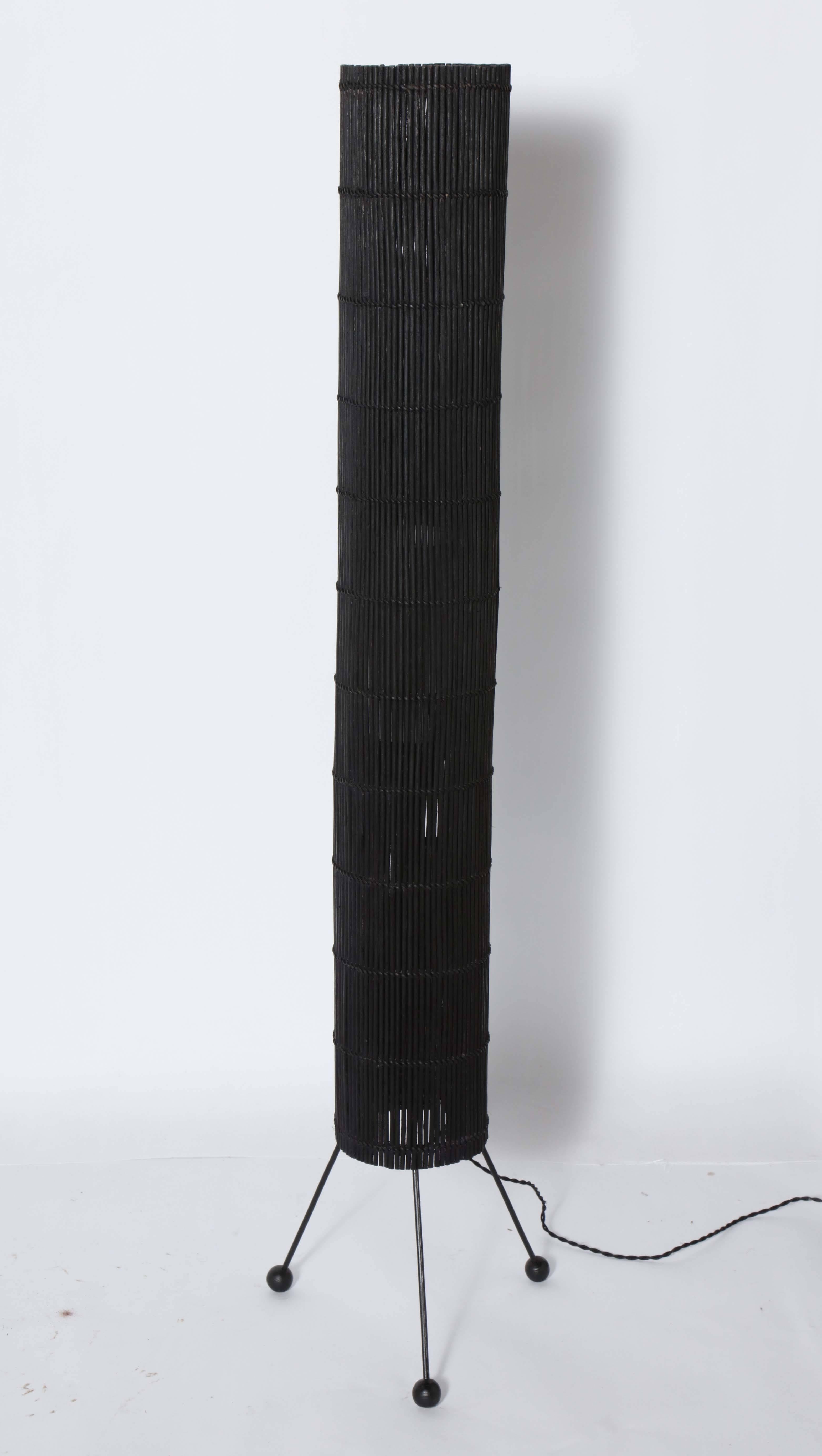 Tall California Contemporary Woven Black Rattan Floor Lamp, in the manner of Tony Paul for Raymor.  Featuring a slender Organic Modern cylindrical Black wicker Shade, narrow cylindrical interior White Linen Shade (4.25D x 8H), on Black Wrought Iron