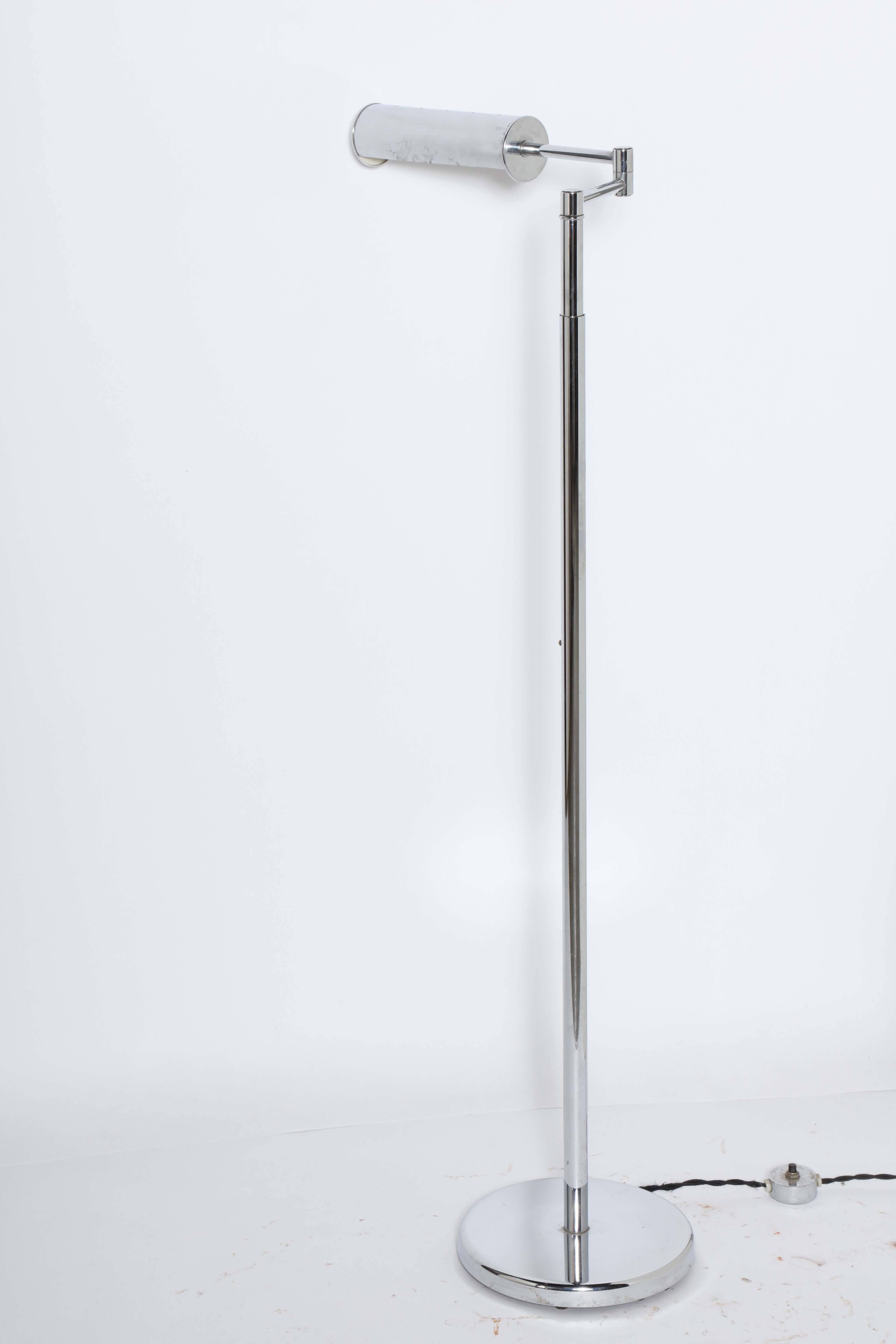 1960s International style Nessen Studios Adjustable swing arm Chrome Floor Lamp. Featuring Chrome adjustable height stem, vented cylindrical Chrome shade with round Chrome base. Lamp head measures 9L. Width of Lamp and arm in feature photo measures