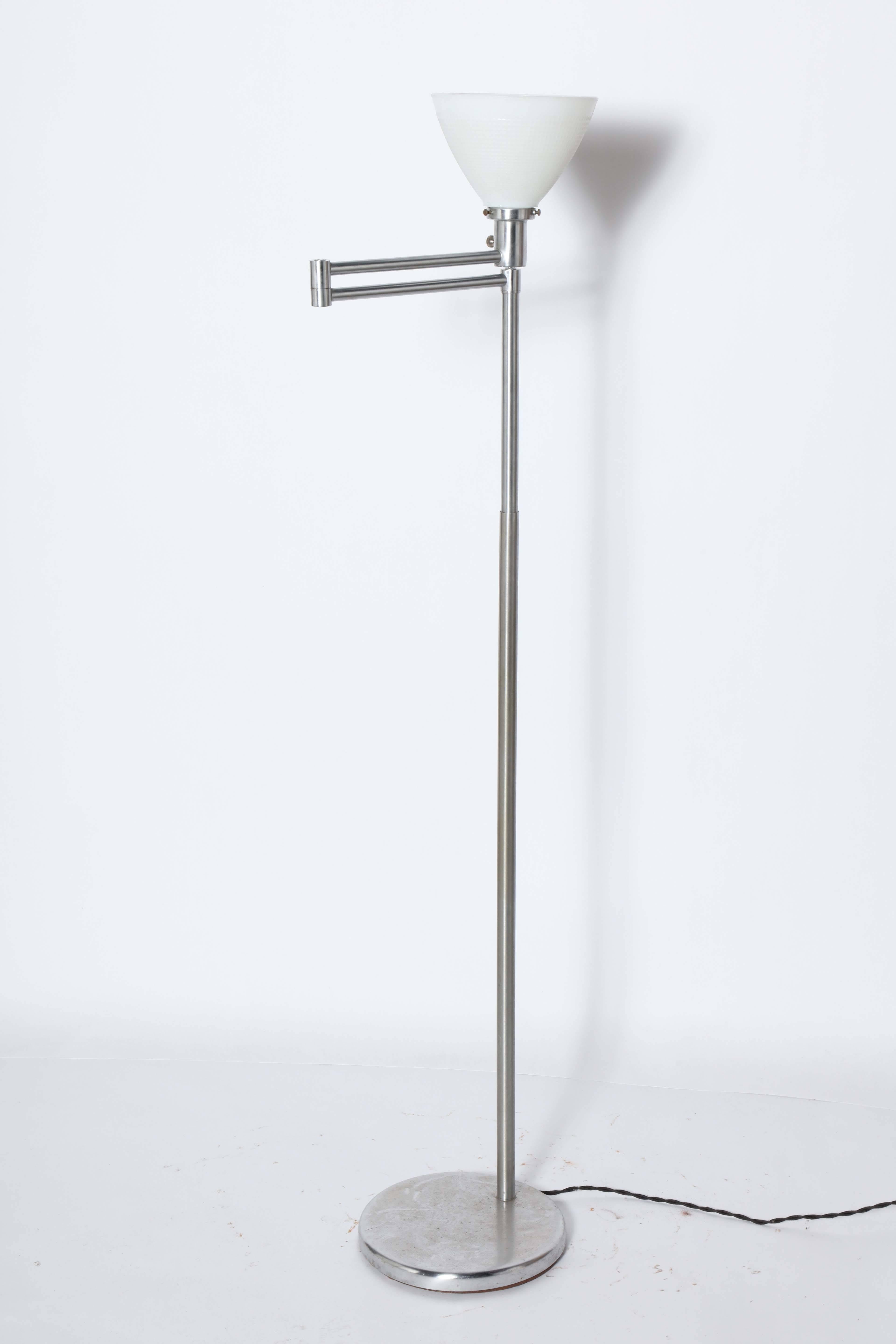 Walter Von Nessen designed Brushed Steel Swing Arm Reading Floor Lamp with White Glass Shade, 1950's. Small footprint. Featuring an adjustable Brushed Steel swing arm with White Milk glass liner shade Arm extends to 17D. Timeless. Classic. Fine