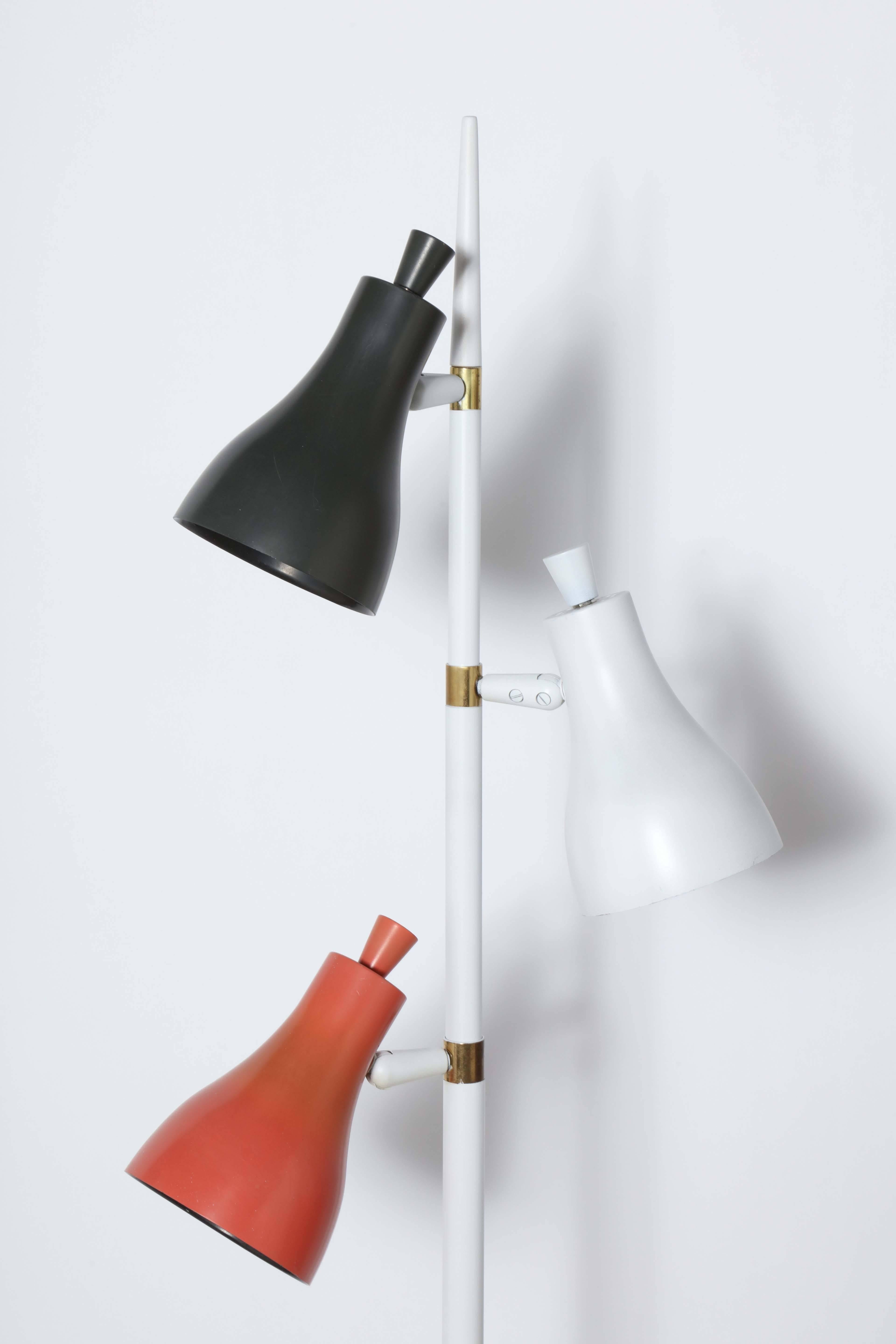 1950's Gerald Thurston for Lightolier adjustable Tri Color, Tri Shade Floor Lamp. Featuring Three adjustable enameled Shades in Black, White and Pale Salmon, adjustable White tubular stem with Brass details, on a round 11D White base. Versatile.