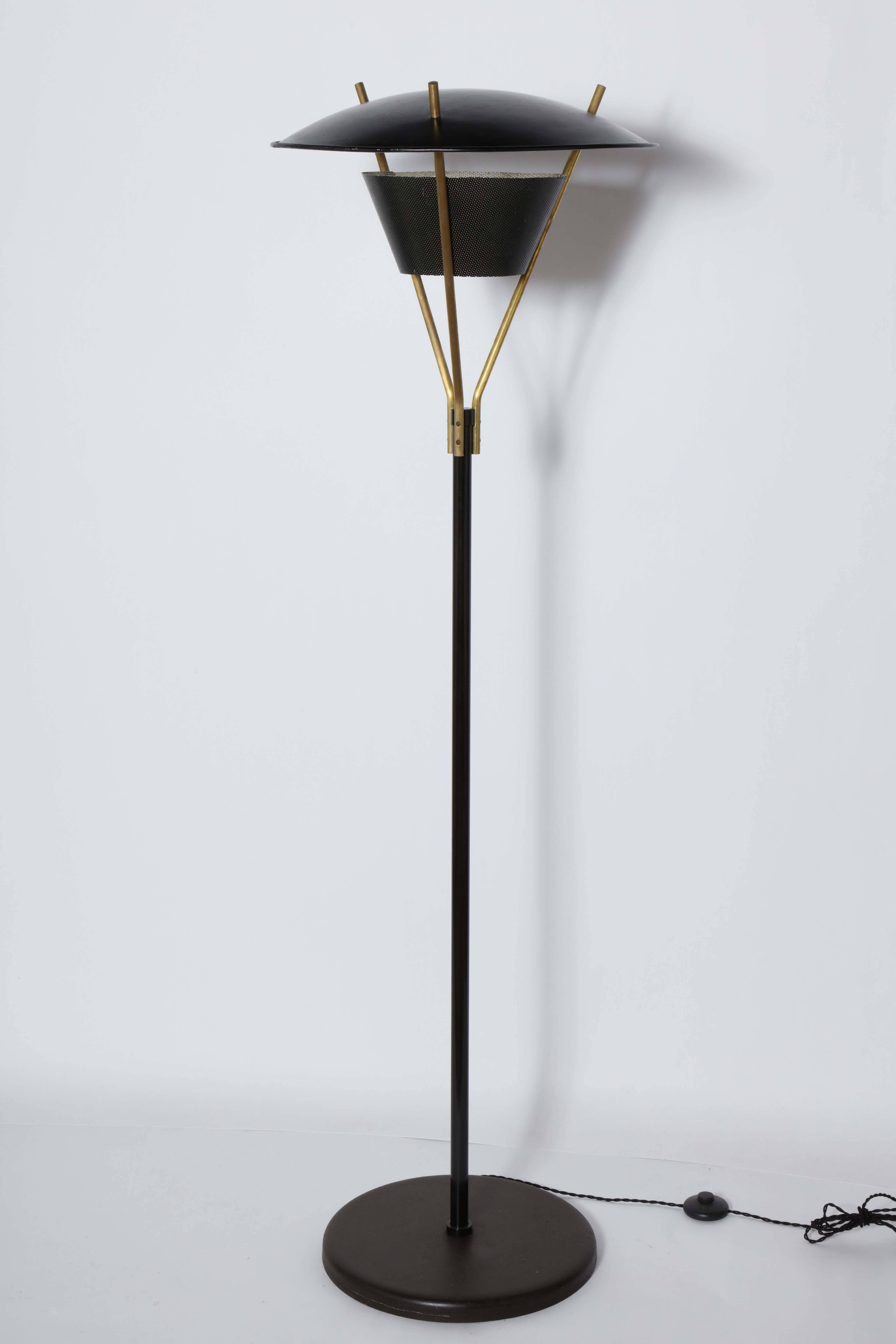 Substantial Thomas Moser for Lightolier Black Enamel and Brass Floor Lamp from the 1950's. Featuring tubular Black enameled column, Brass tripod arms, rounded 20D Black hood Shade with White interior, perforated Black cone neck with White Interior