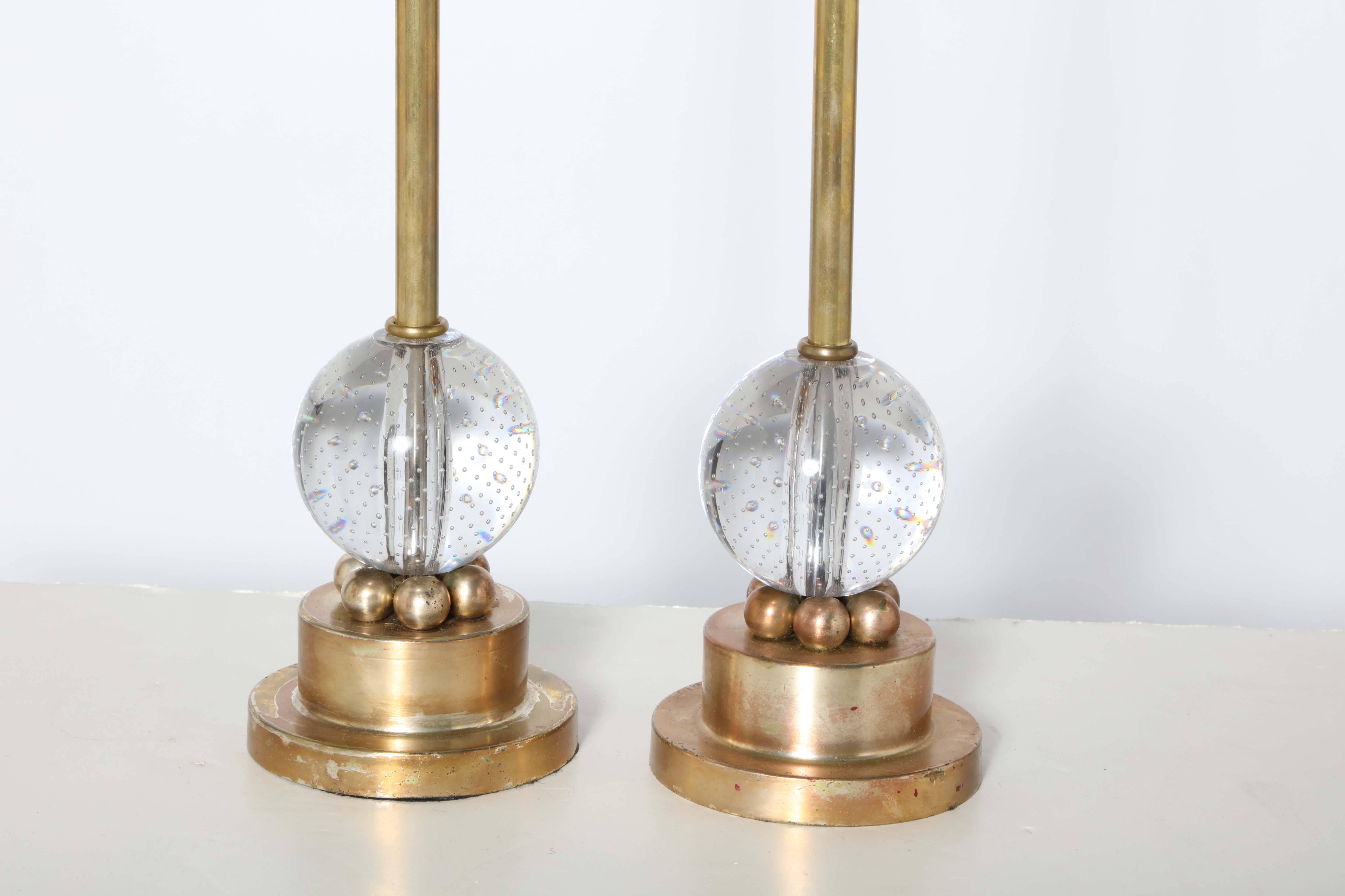 Pair of Murano Glass Globe and Brass Hollywood Regency Thin Candlestick Table Lamps.  Featuring a slender cylindrical Brass center column, round 4D clear controlled bubble Glass spheres, six smaller, lower (3/4D) Brass sphere surround details on a