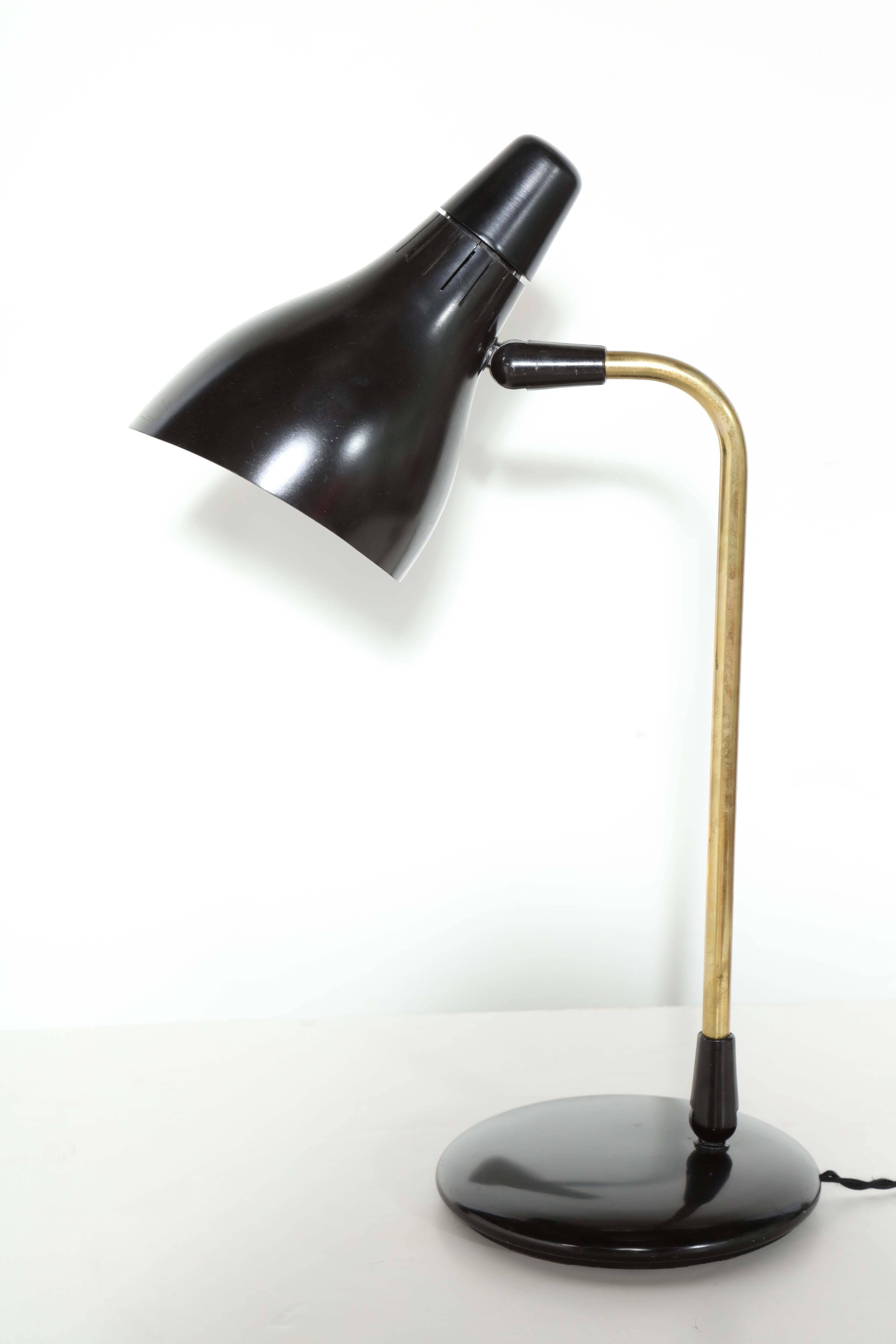 Classic MCM Gerald Thurston for Lightolier Library Lamp. Featuring single cone Black enameled metal adjustable shade, articulating Brass arm on heavy round 7