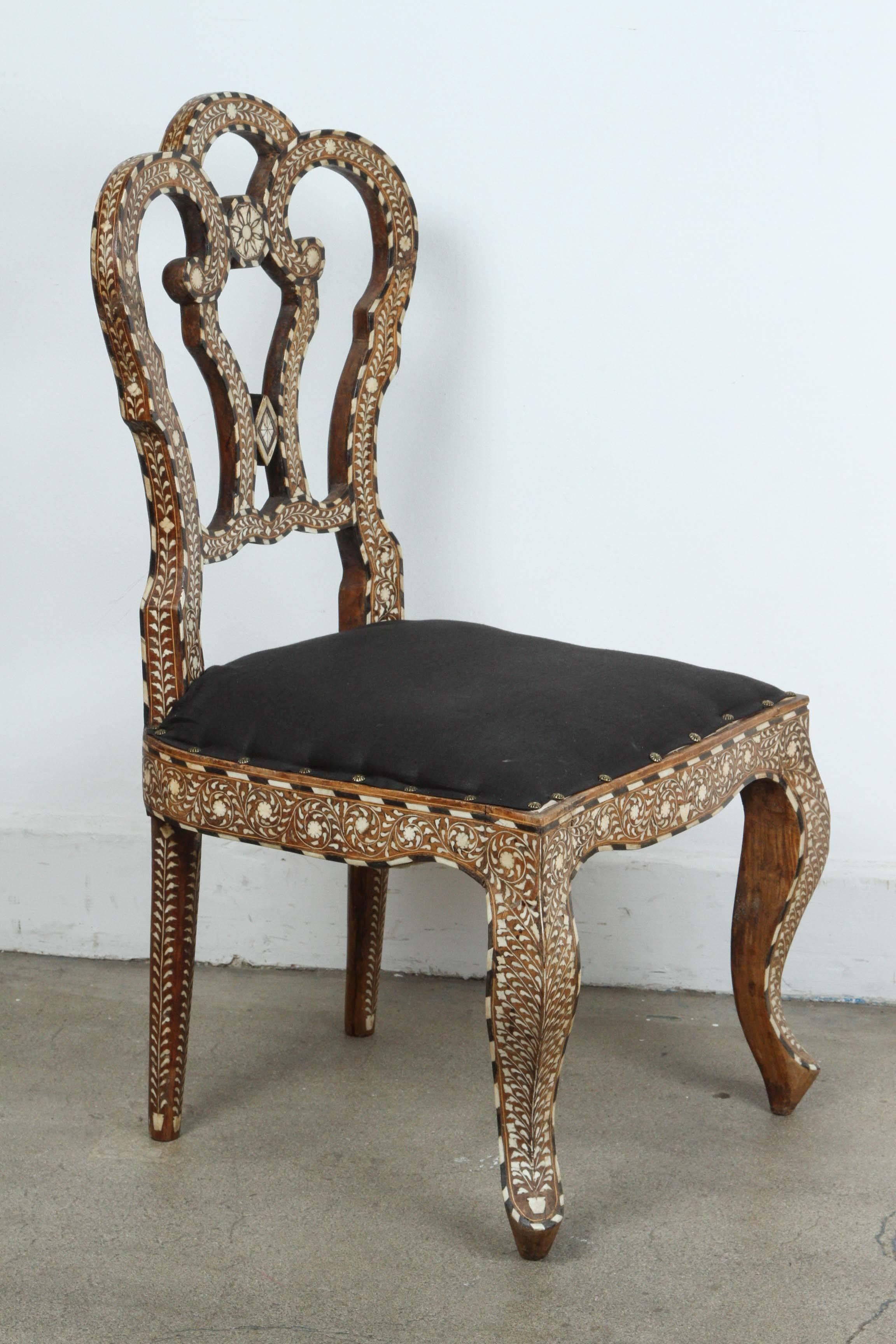 19th Century Anglo-Indian ebony and bone inlay side chair.
Inlaid throughout with scrolling vine-work and flower-heads, open interlaced back and upholstered seat raised on front cabriole legs.
Some losses of ebony and bone inlay, some structural