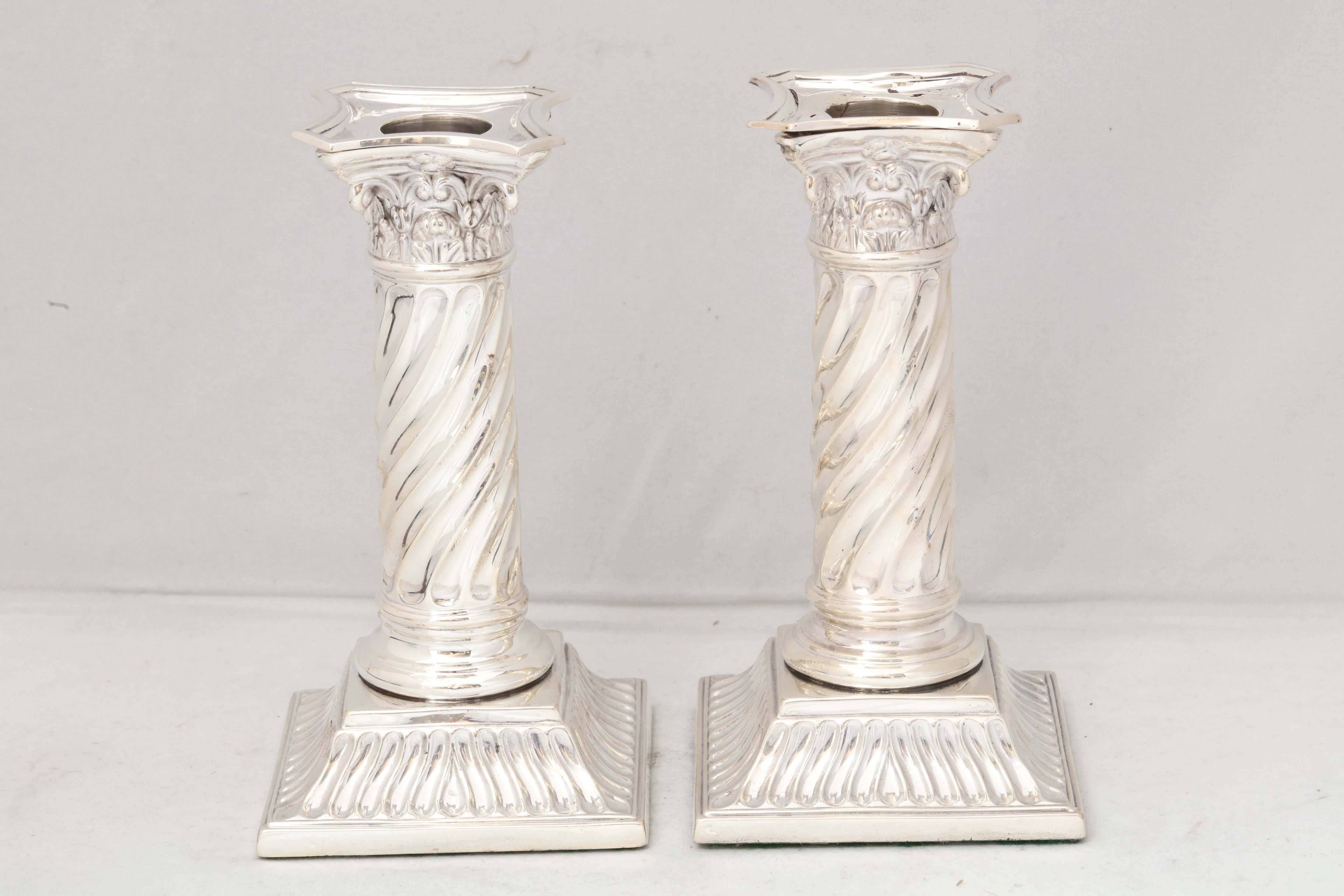 Unusual pair of sterling silver, Victorian, Neoclassical, column-form candlesticks, Sheffield, England, 1899, Martin and Hall - makers. Columns are spiral in design. Removable bobeches. Each measures 6 inches high x 3 1/4 inches wide x 3 1/4 inches
