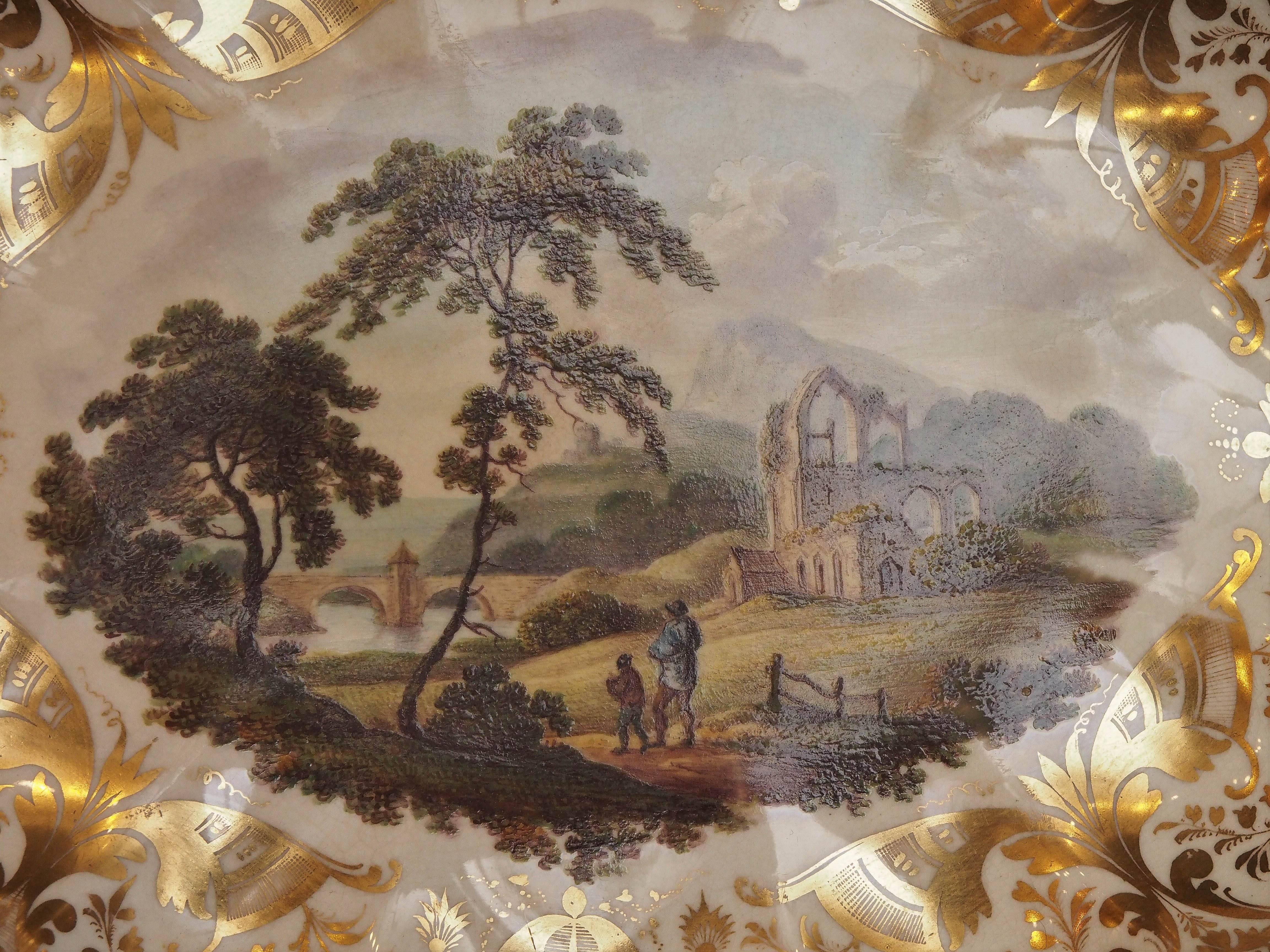 Derby scalloped dish with pastoral painted scene with gilt border decoration.