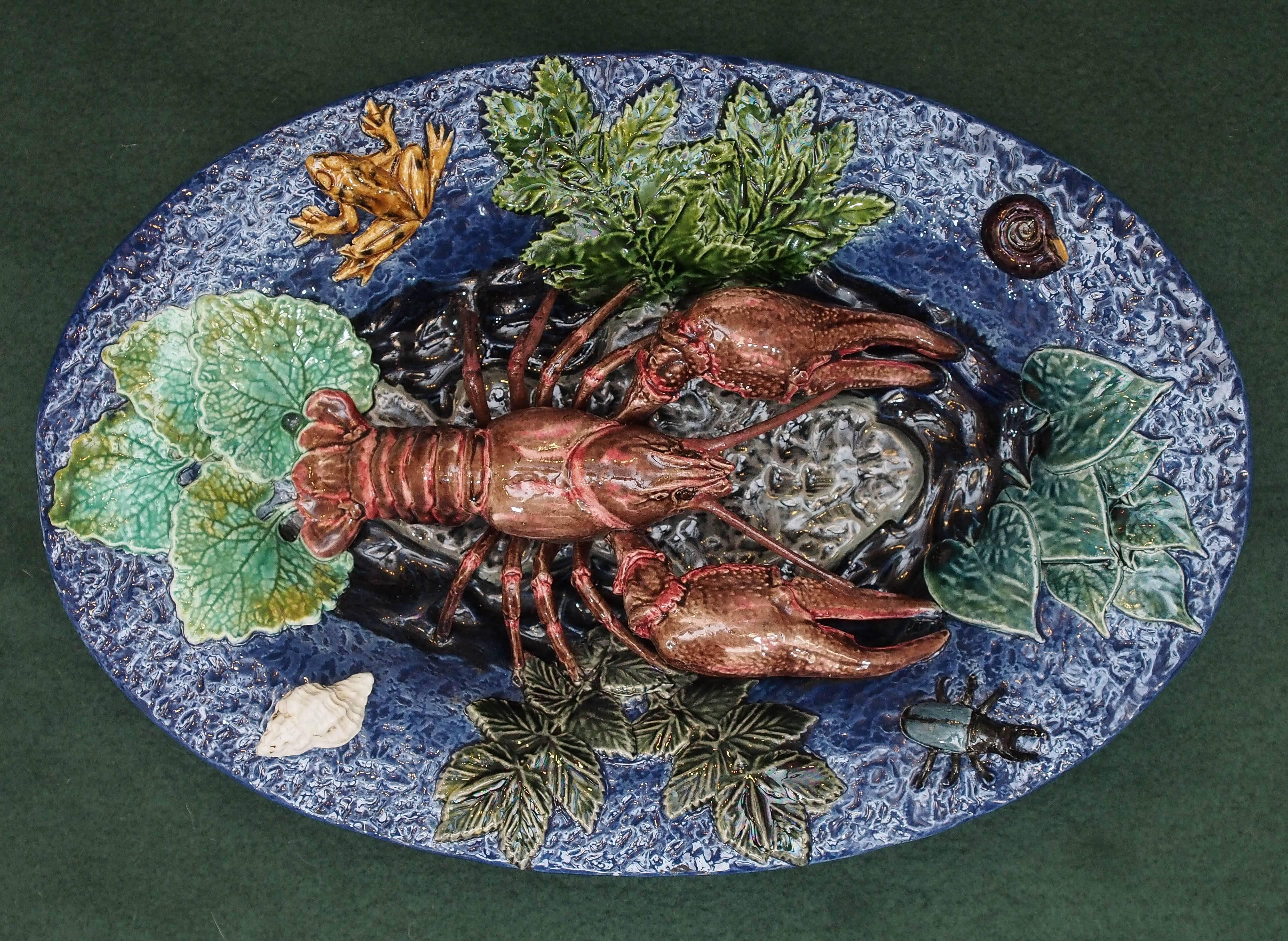 Portuguese Pallisy style platter with langoustine and frog on blue ground.