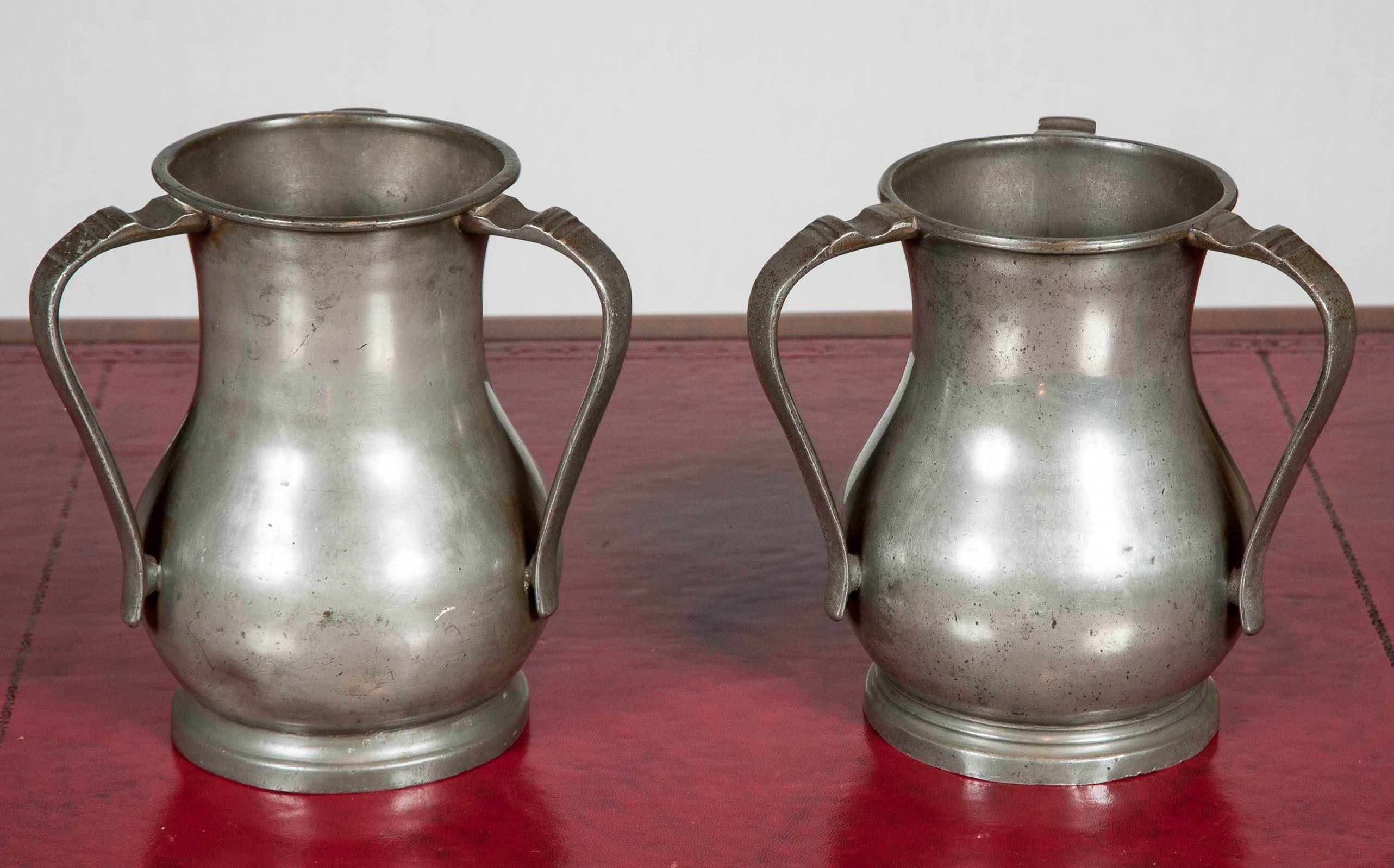 A rare closely matched pair of late 18th century pewter three handled loving cups or passing cups. These appear to have originated in the Bristol area. One is marked with B&P (item 740, page 173 in ‘Cotterell’), Robert Bush and Richard Perkins,