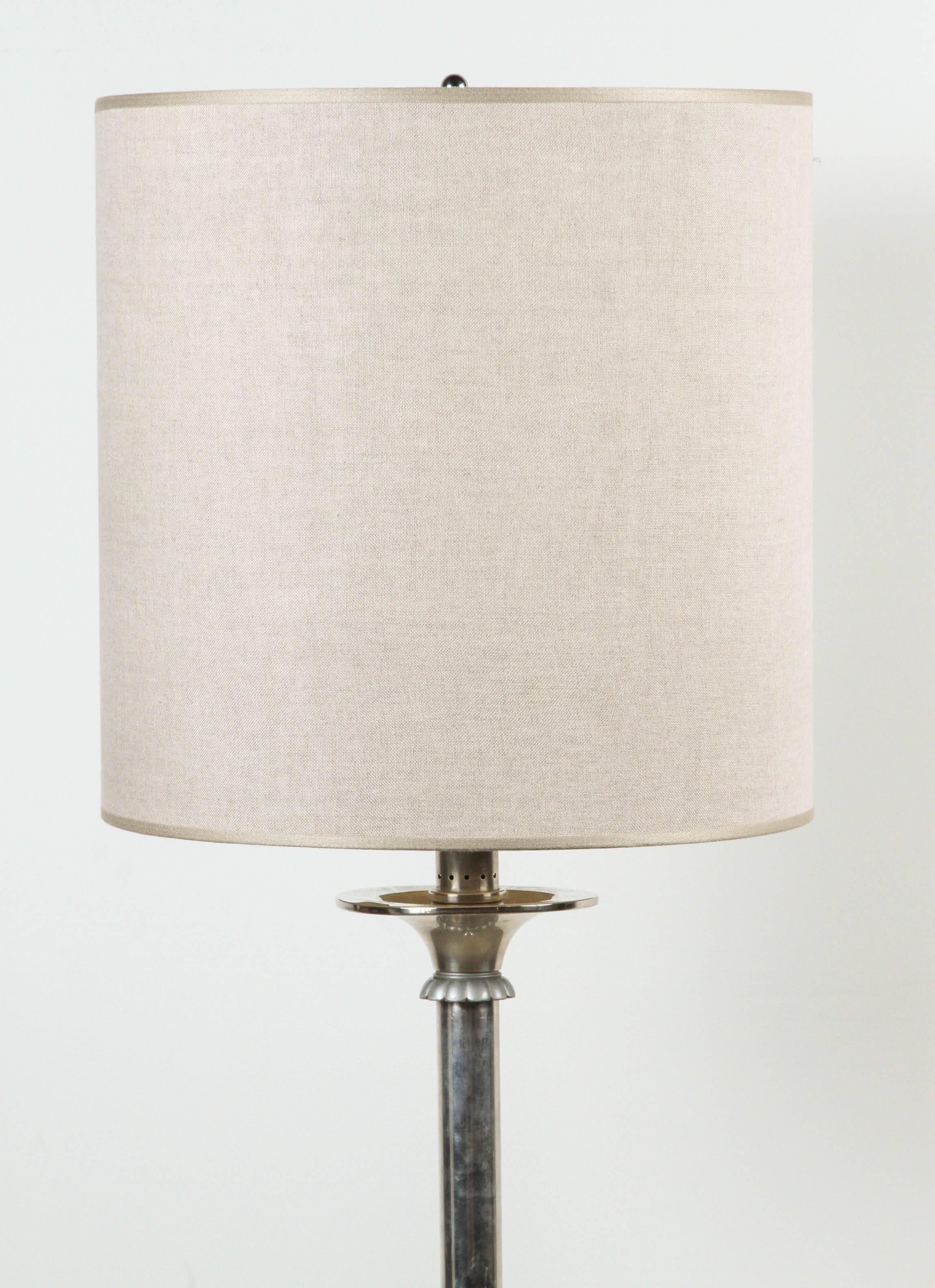 Italian silver floor lamp with flower detail and an oversized lampshade.