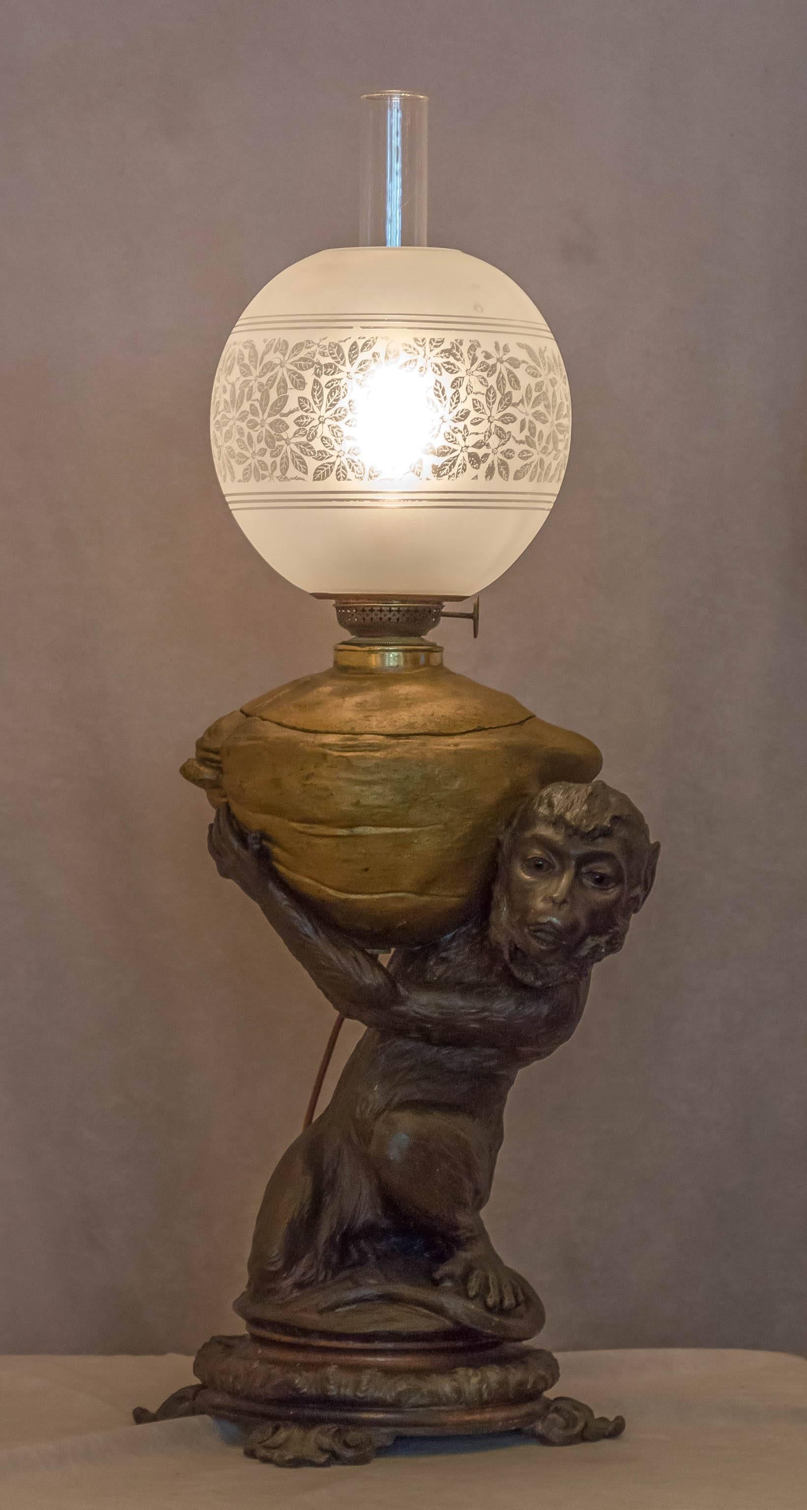 We do have a weakness for the whimsy, hence the monkey and coconut lamp. This lamp is so much fun and now can be used without adding oil, as it has been electrified. As an added quality characteristic, the monkey's eyes are glass. The shade is an