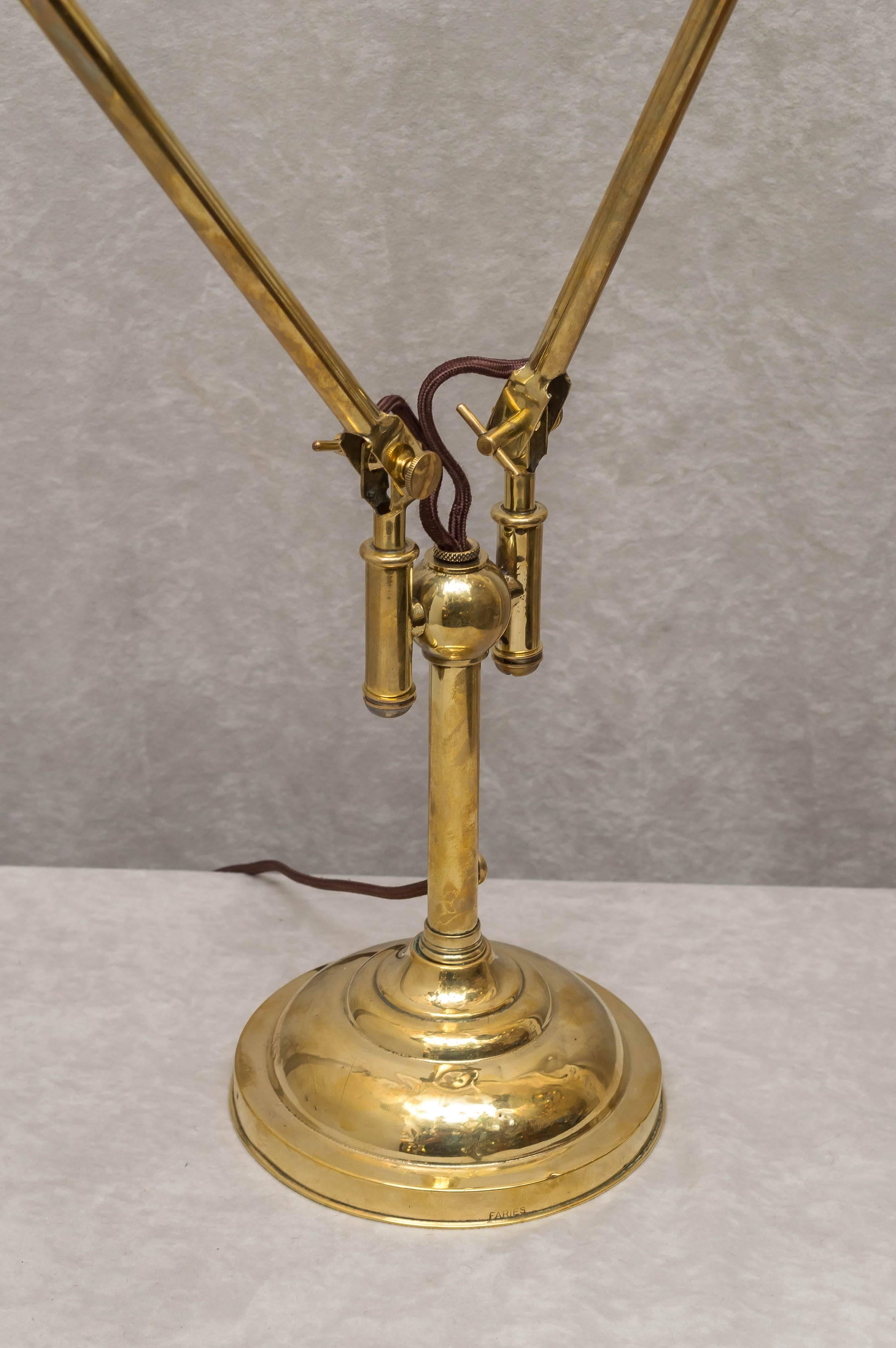 This fascinating gem of a lamp is incredibly rare. While we have sold dozens of single arm lamps of this type, we have had only one other double arm. This adjusts in so many ways it's pointless to try to explain. There are knuckles for adjustment at