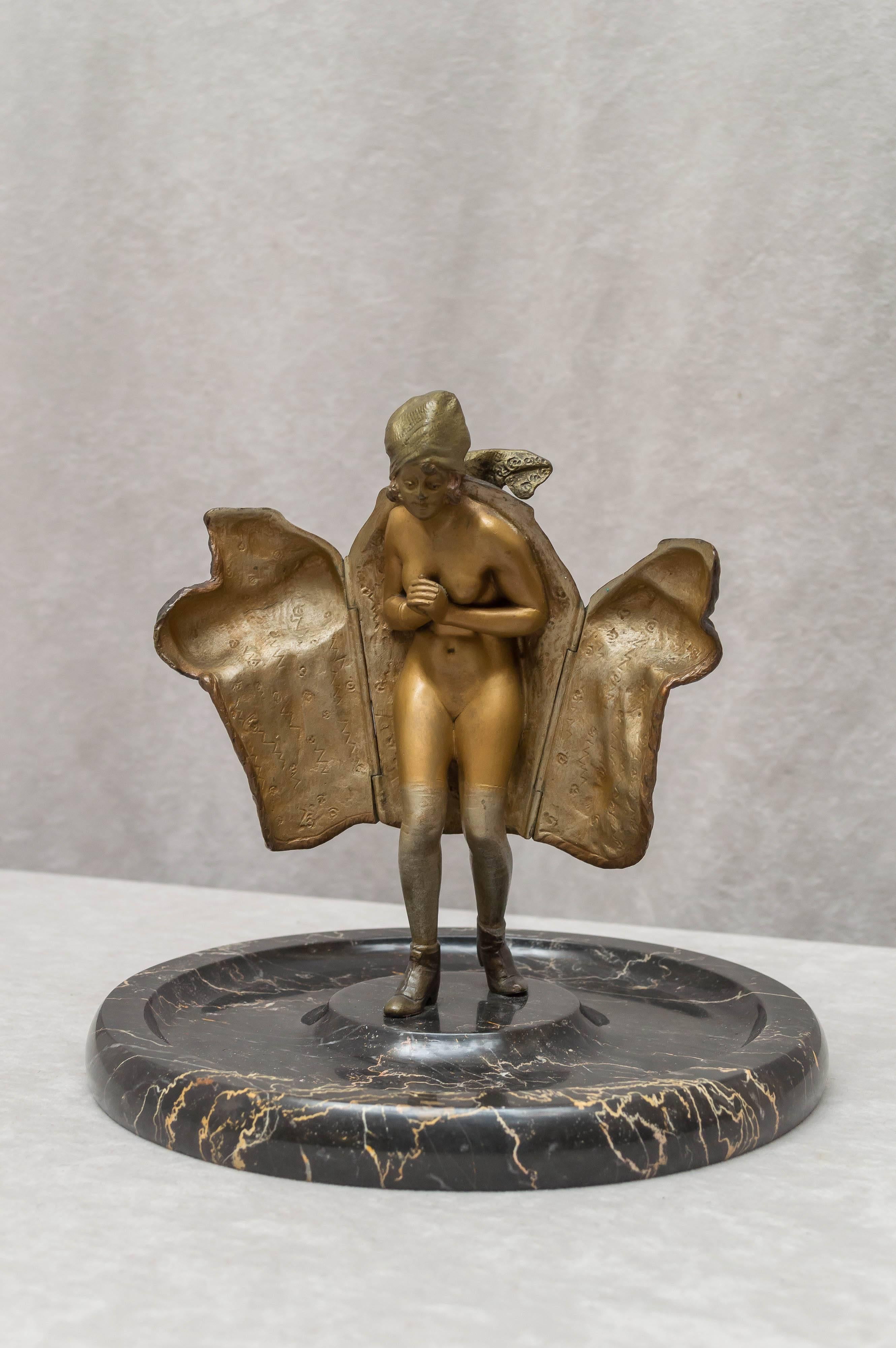 This has always been one of our favorite naughty bronzes. This lovely gal, wearing her finest fur coat, is willing to open it up to reveal her nude body. This bronze is in remarkable condition. Normally there is lots of wear to the nude, as well as