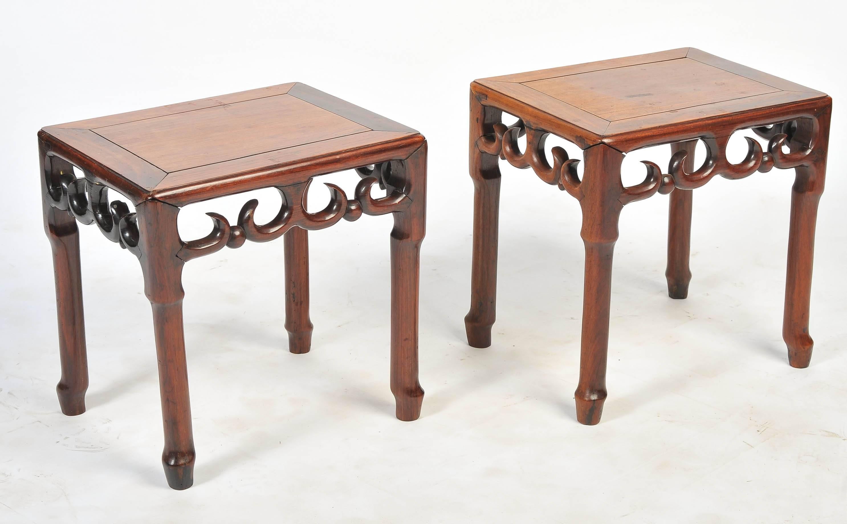 A good quality pair of 19th century Chinese hardwood side tables having an inset wooden top, carved frieze and legs.
