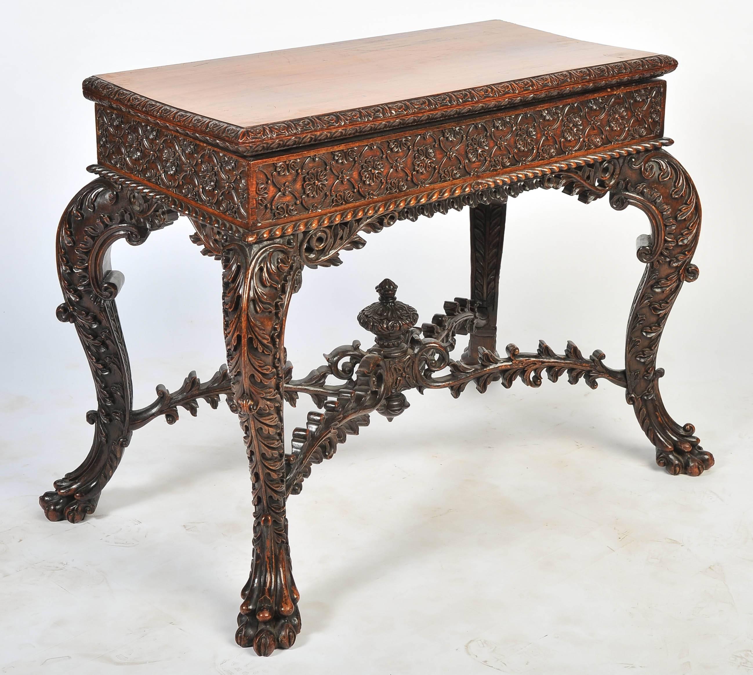 A very impressive pair of Anglo-Indian card tables. The tops rotate and open, resting on four beautifully carved cabriole legs, united by an X-stretcher and terminating in carved claw feet.