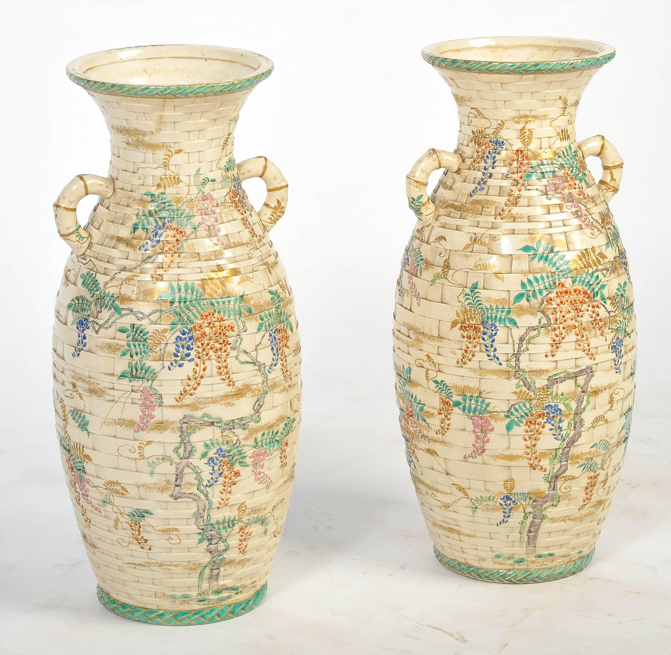 A very decorative pair of Japanese Satsuma vases, having a faux basket weave pattern with bamboo like handles and foliate painted decoration.
We can arrange of this pair of vases to be lamped if needs be, within the price.